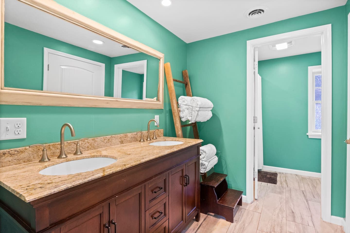 Green bathroom with wooden vanity