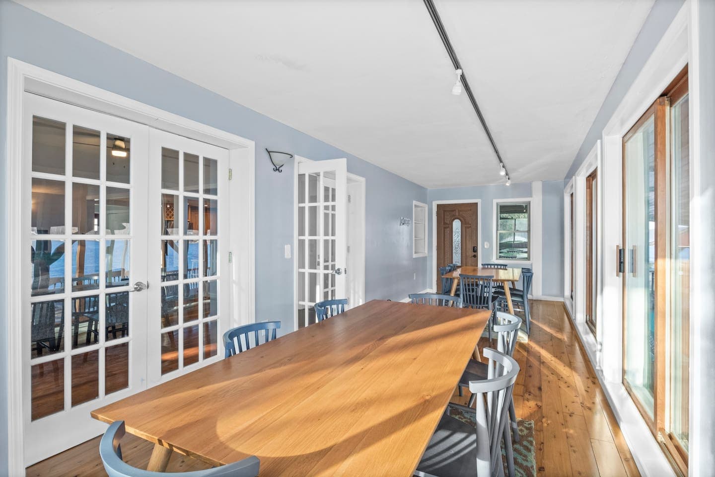 Window-lined room with wood flooring