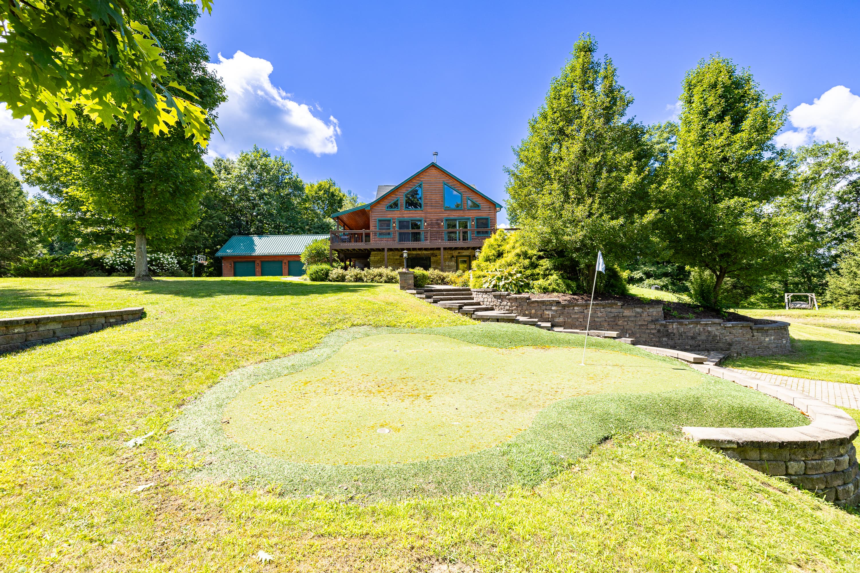 Spacious lawn bordered by mature trees