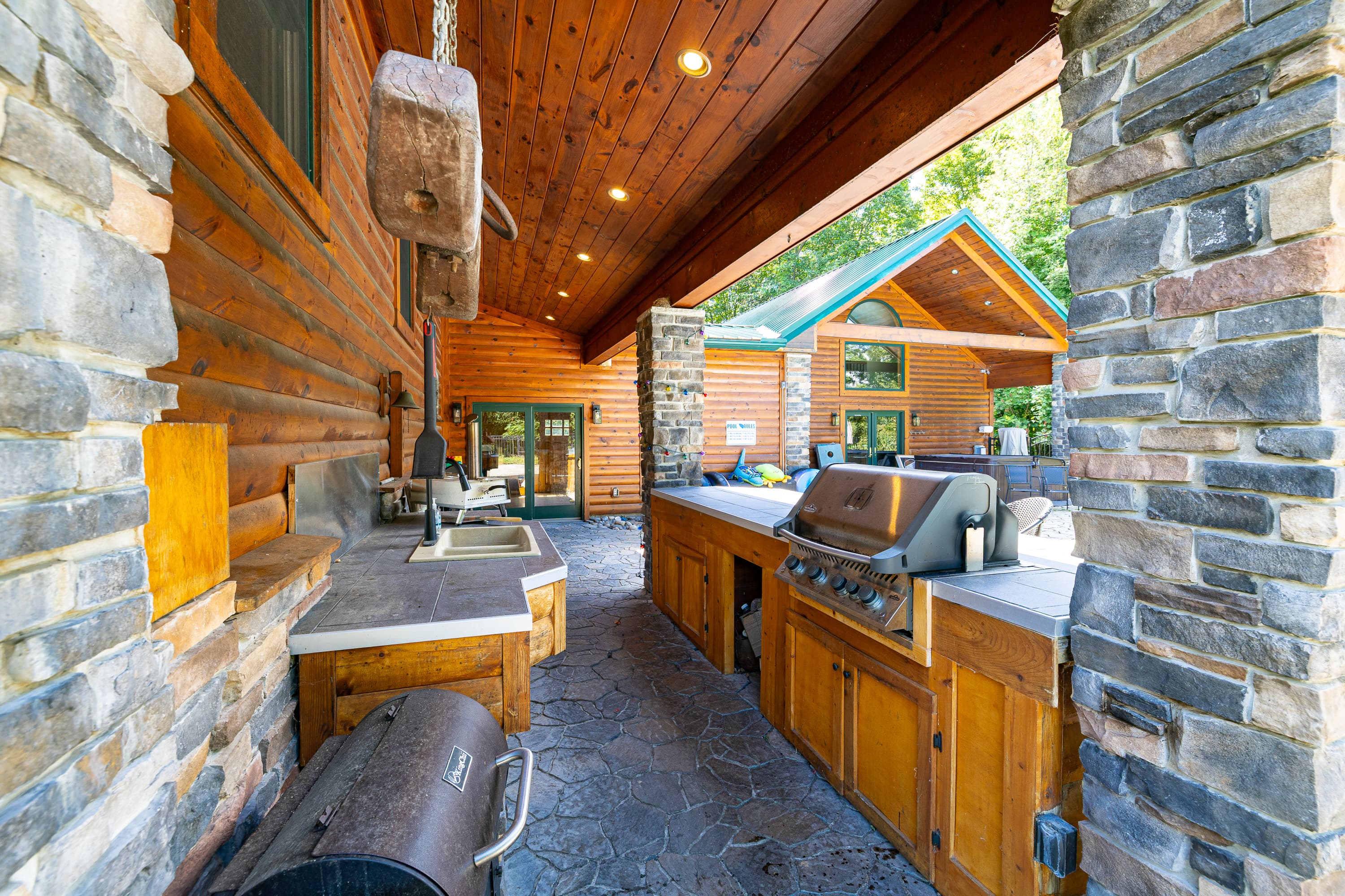 Covered outdoor kitchen with stone counters
