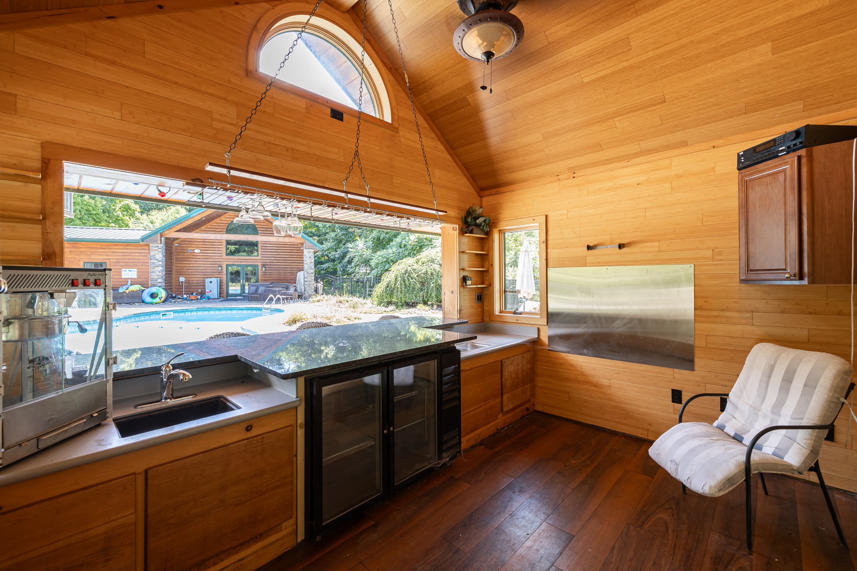 Wood-paneled kitchenette overlooking the pool area
