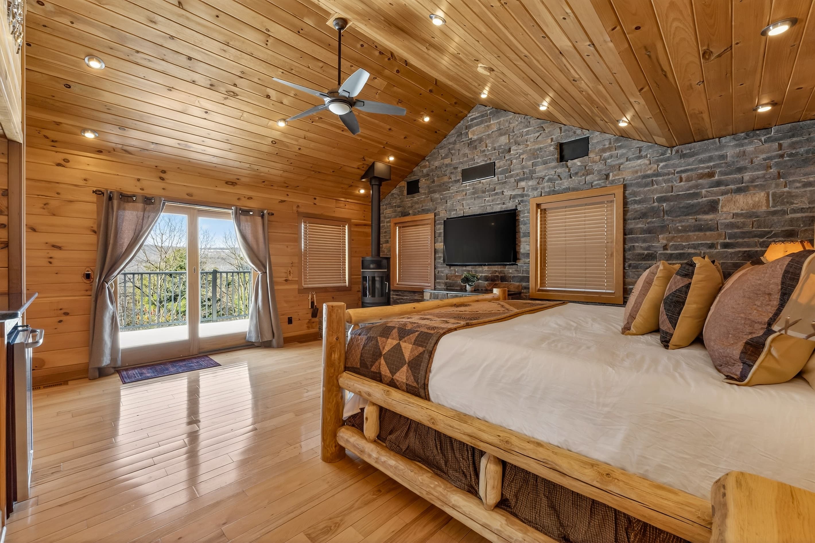 Bedroom with a balcony and ceiling fan