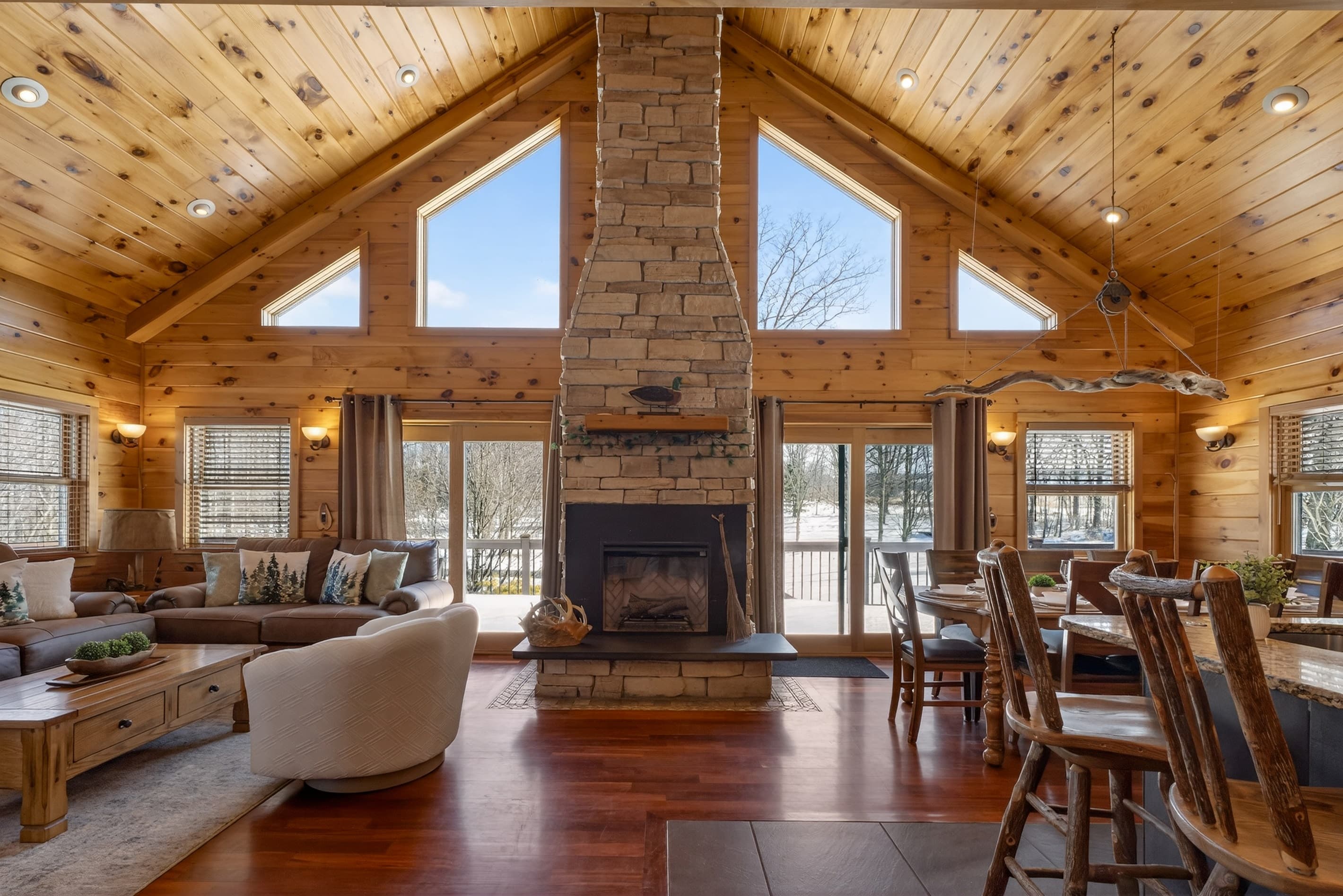 Open living and dining area with wooden ceilings
