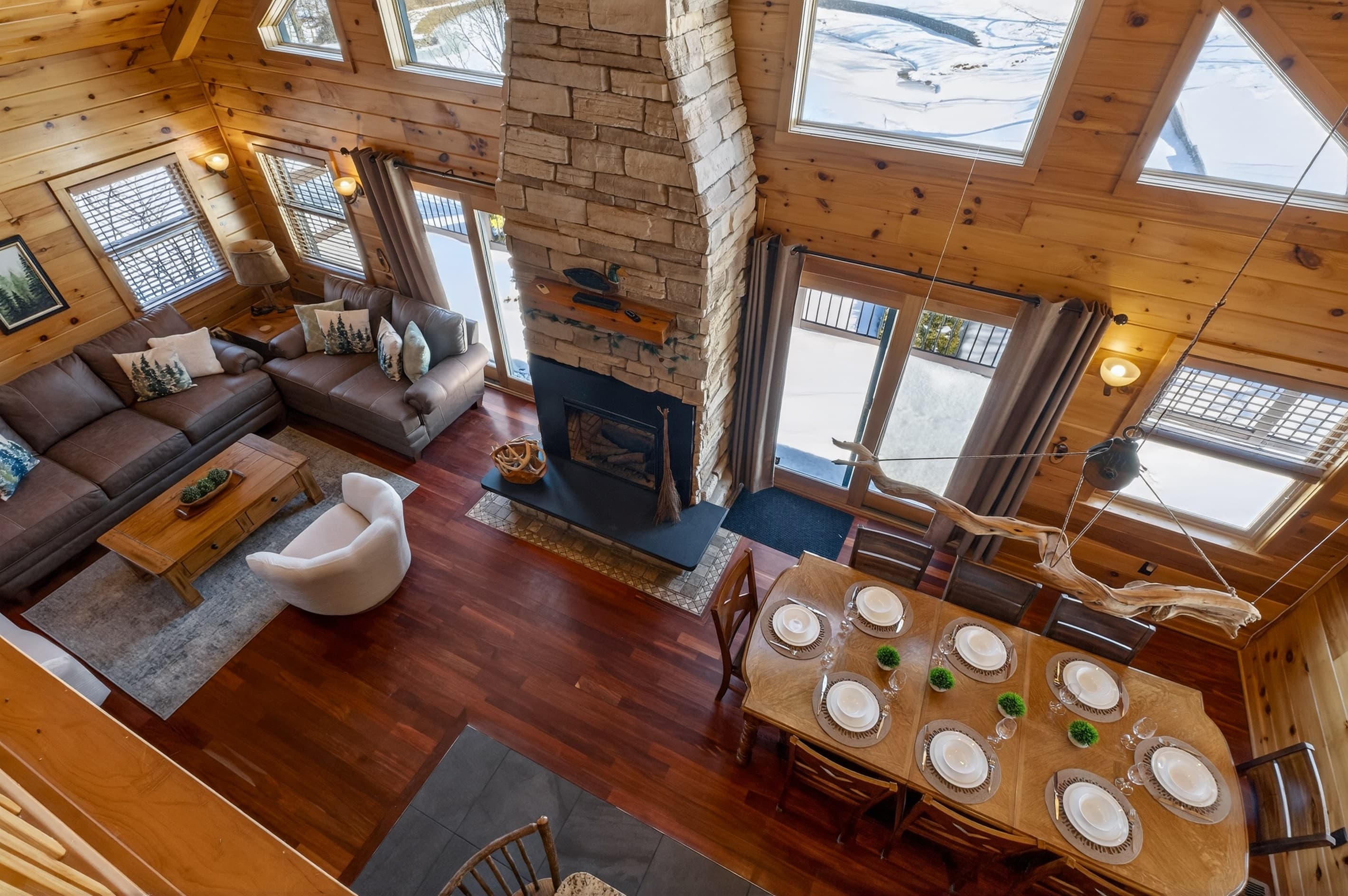 Dining table beside the stone fireplace