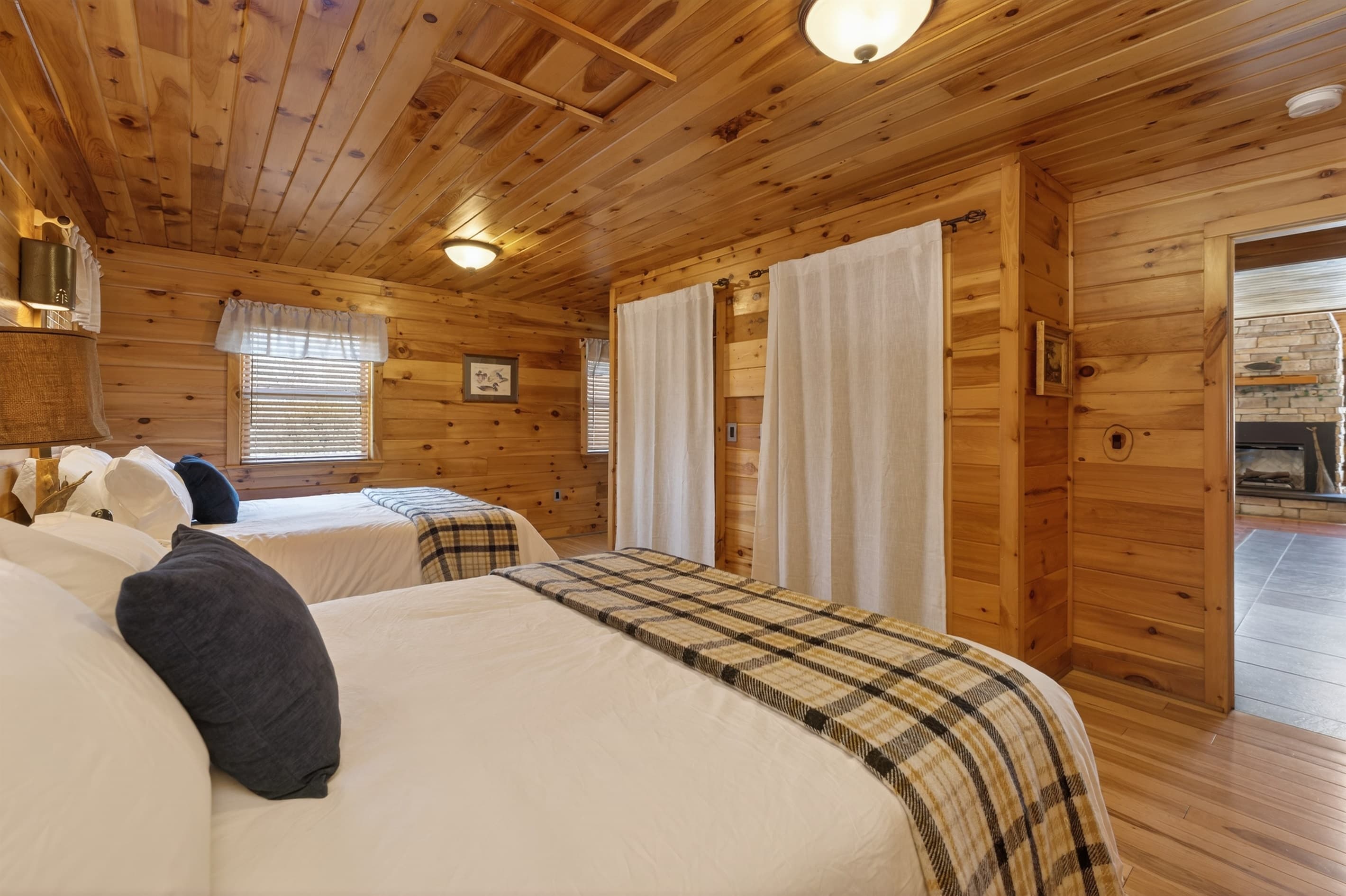 Wood-paneled bedroom with ceiling fan