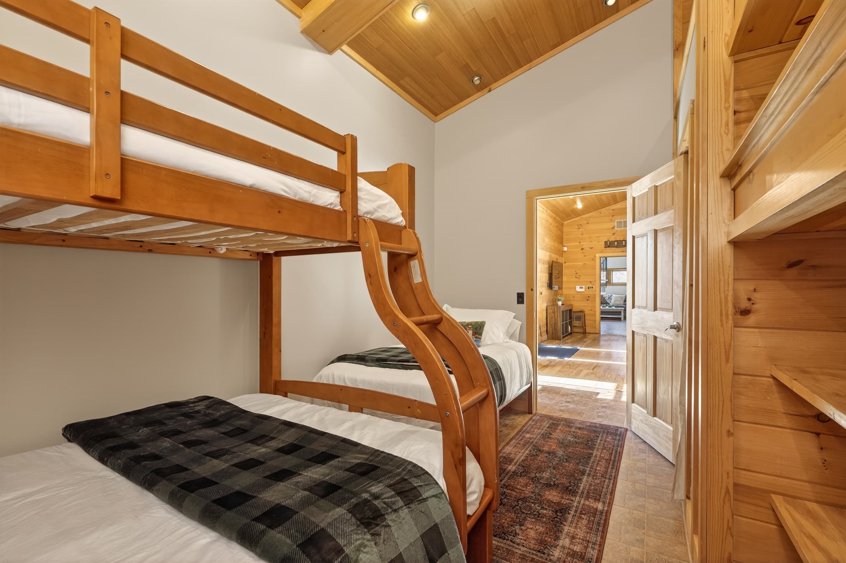 Wooden bunk bed with checkered bedding