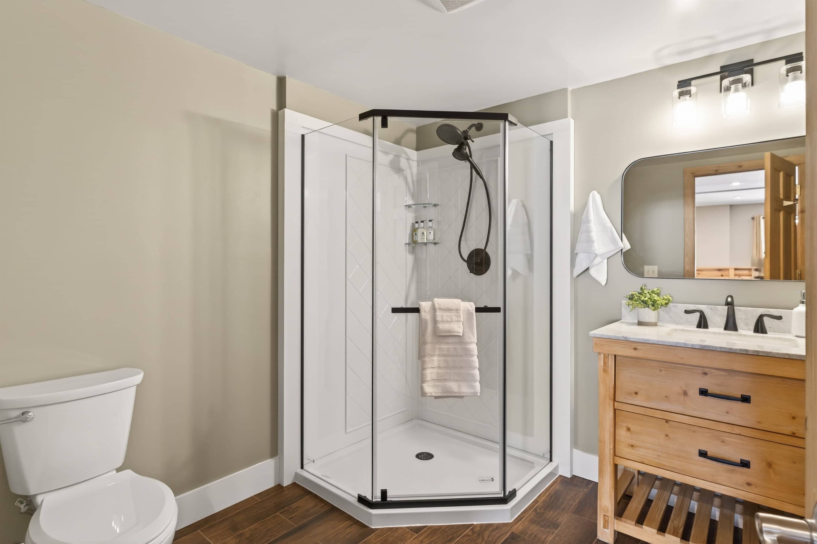 Bathroom with glass-enclosed shower and vanity