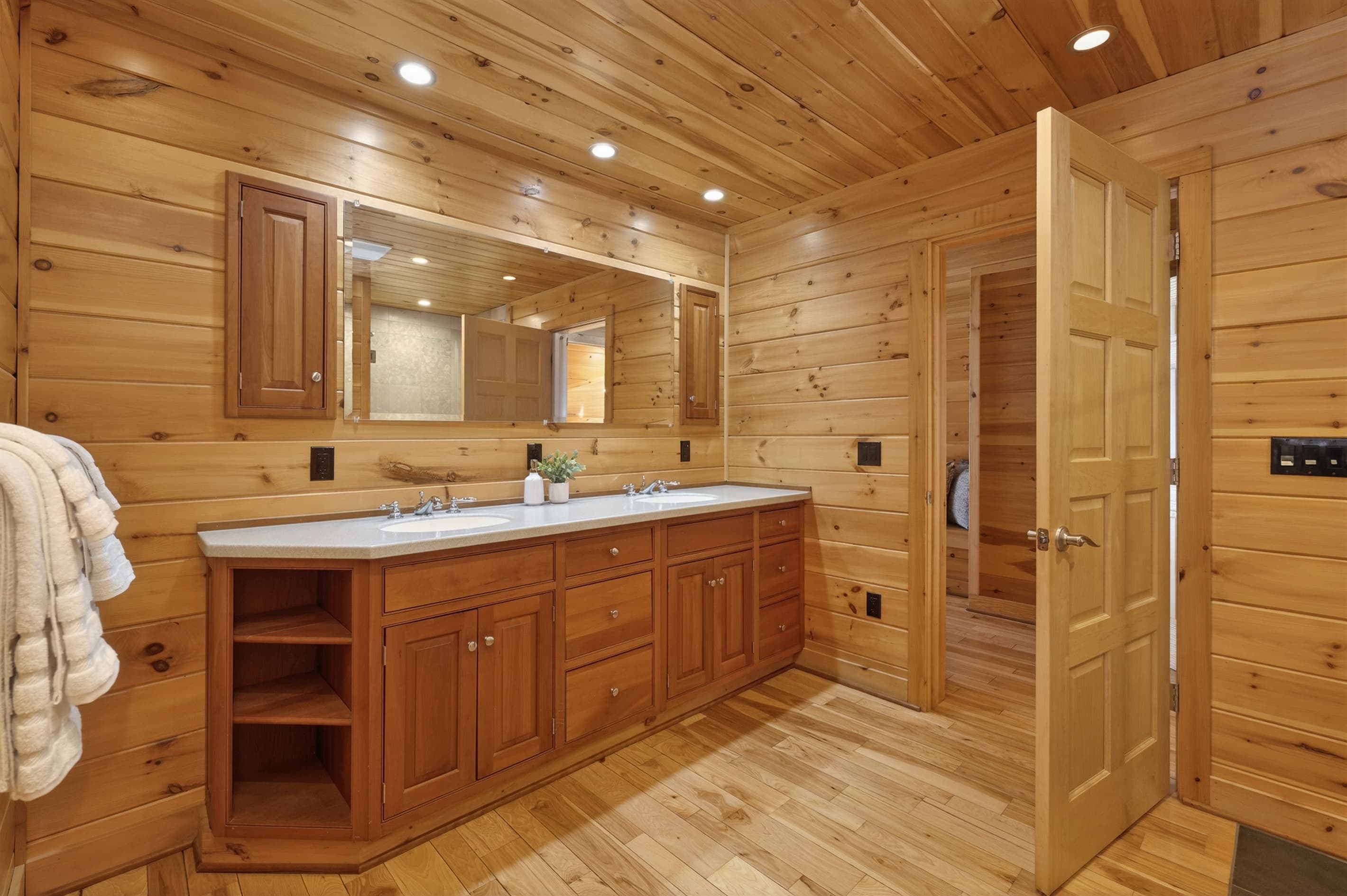 Wood-paneled bathroom with storage cabinets