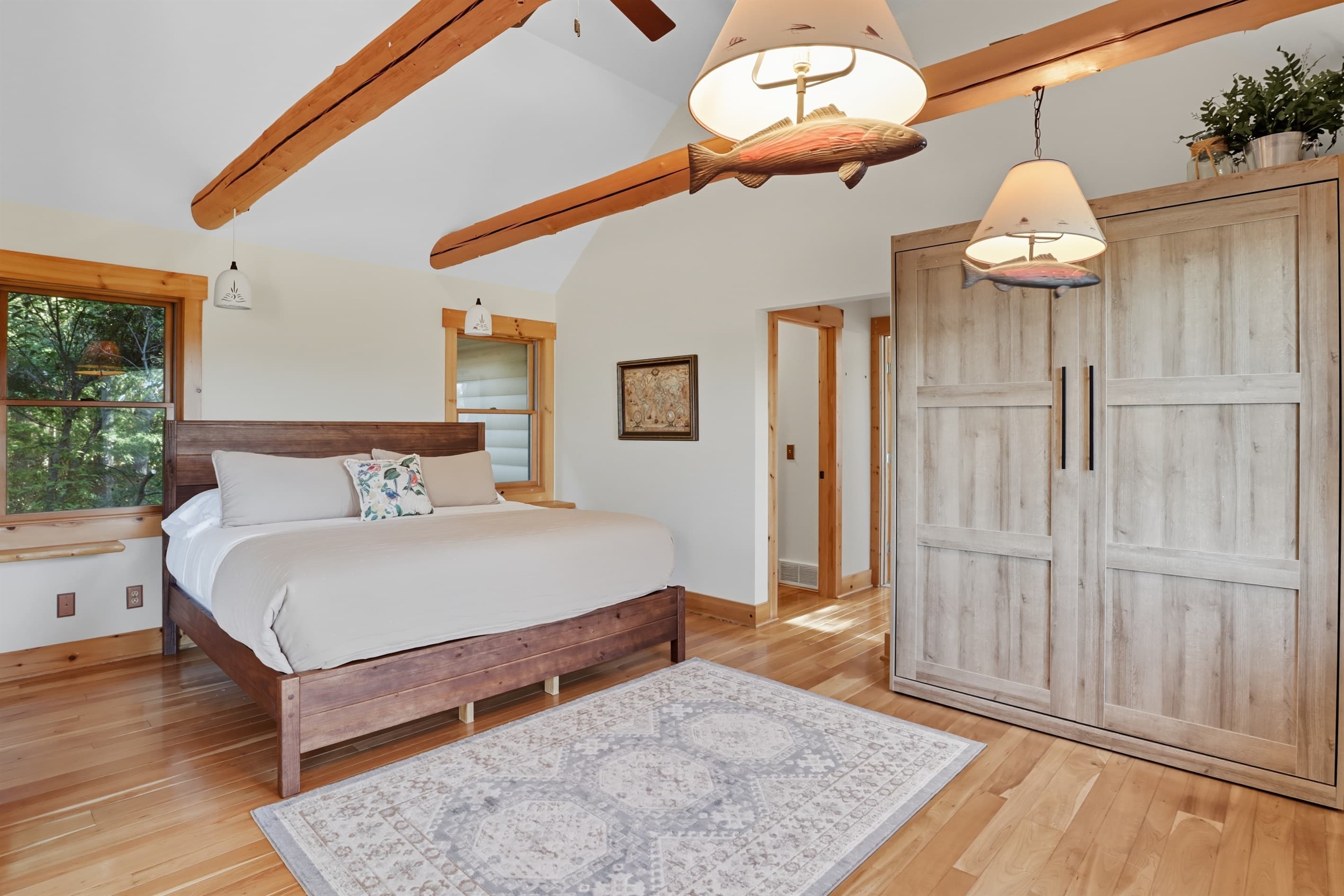 Primary bedroom with king bed and wooden closet