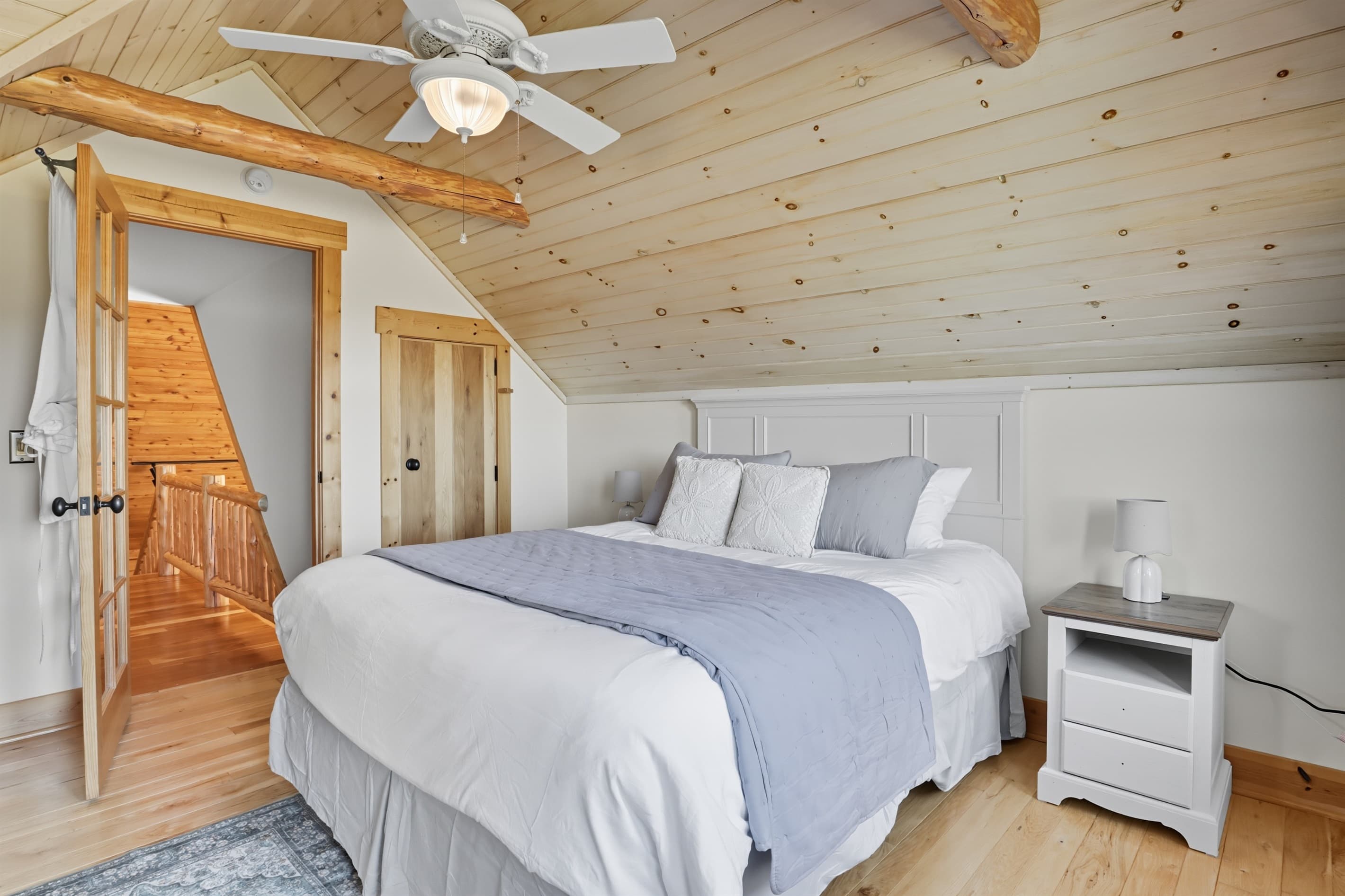 Queen bedroom with dresser and ceiling fan, ensuite bathroom