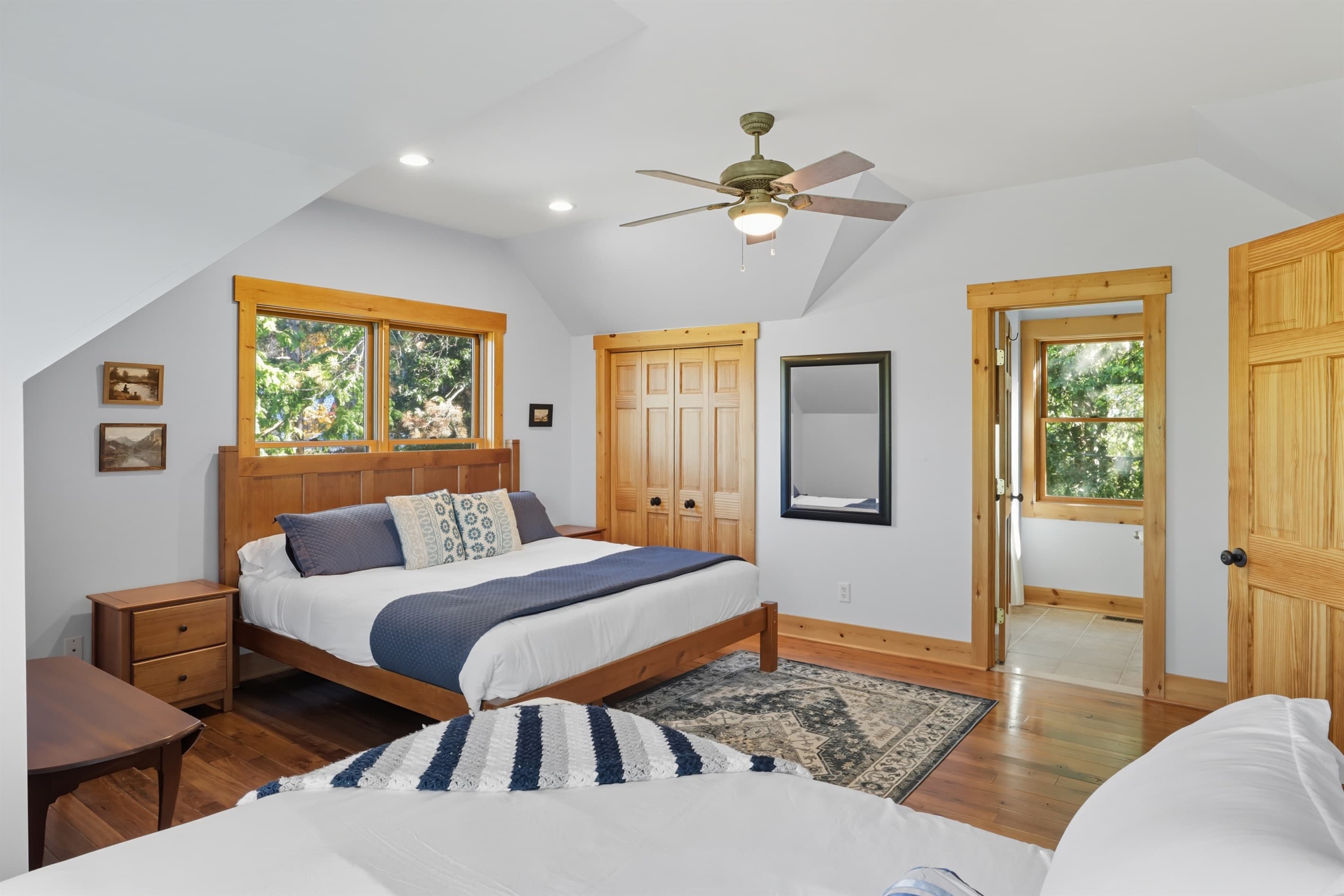 Bedroom with plush bedding and wood accents.