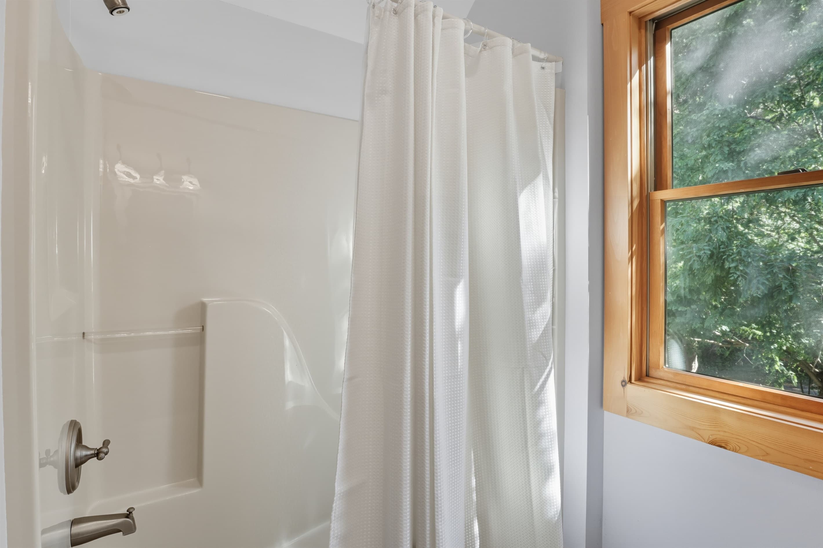Shower area with window and tile surround