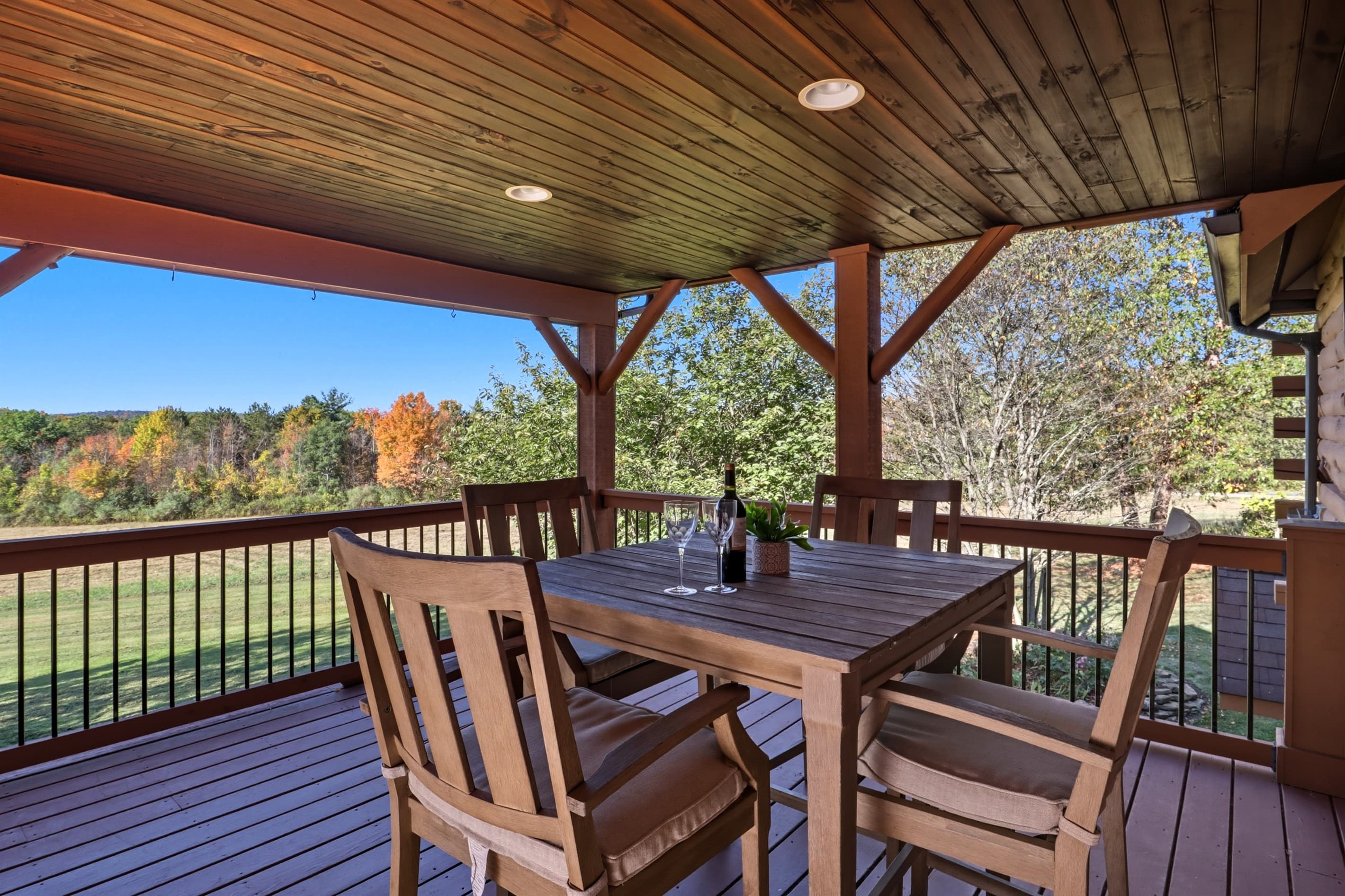 Shaded dining area beneath wooden beams