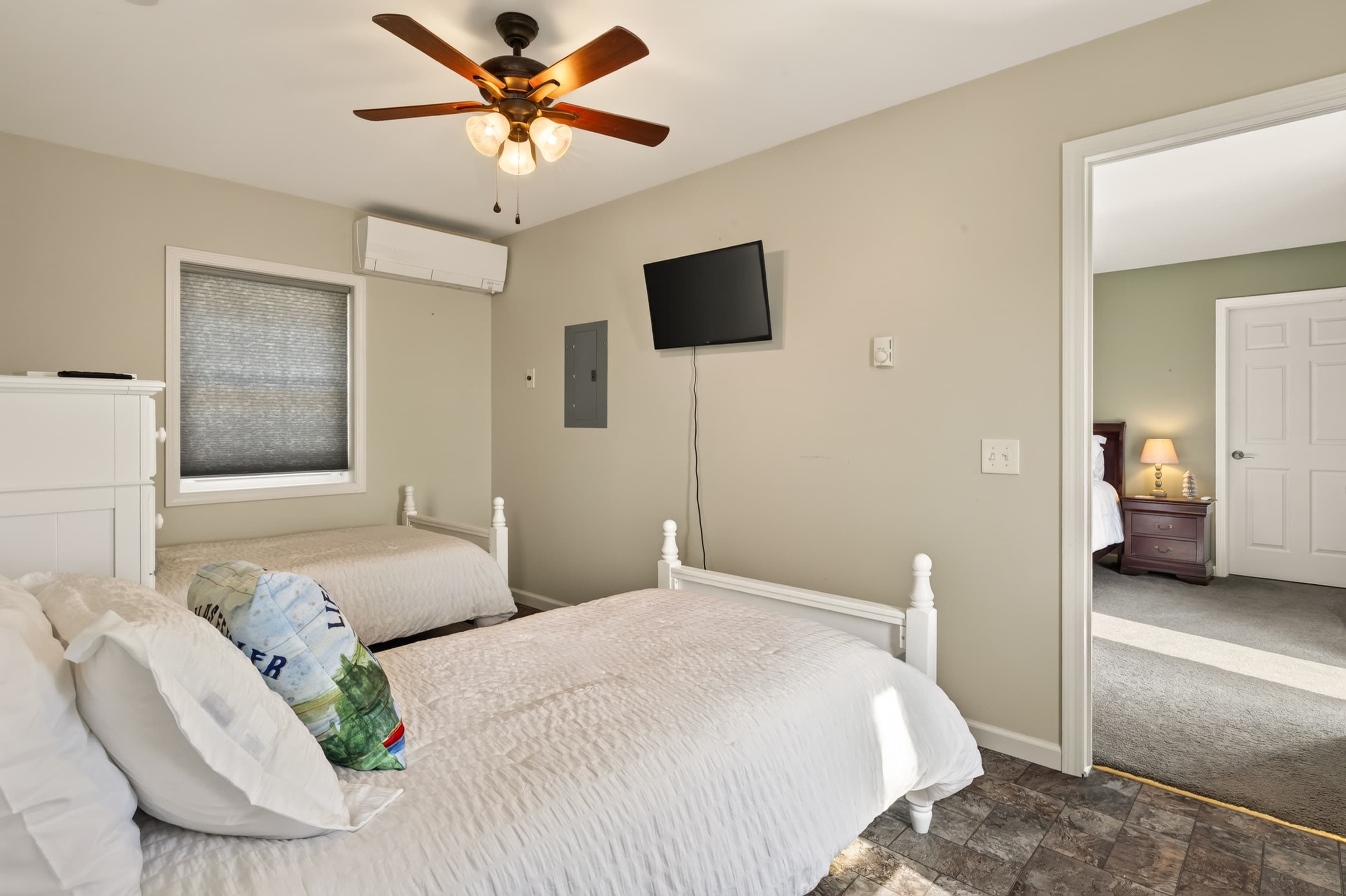Bedroom with white bed and ceiling fan