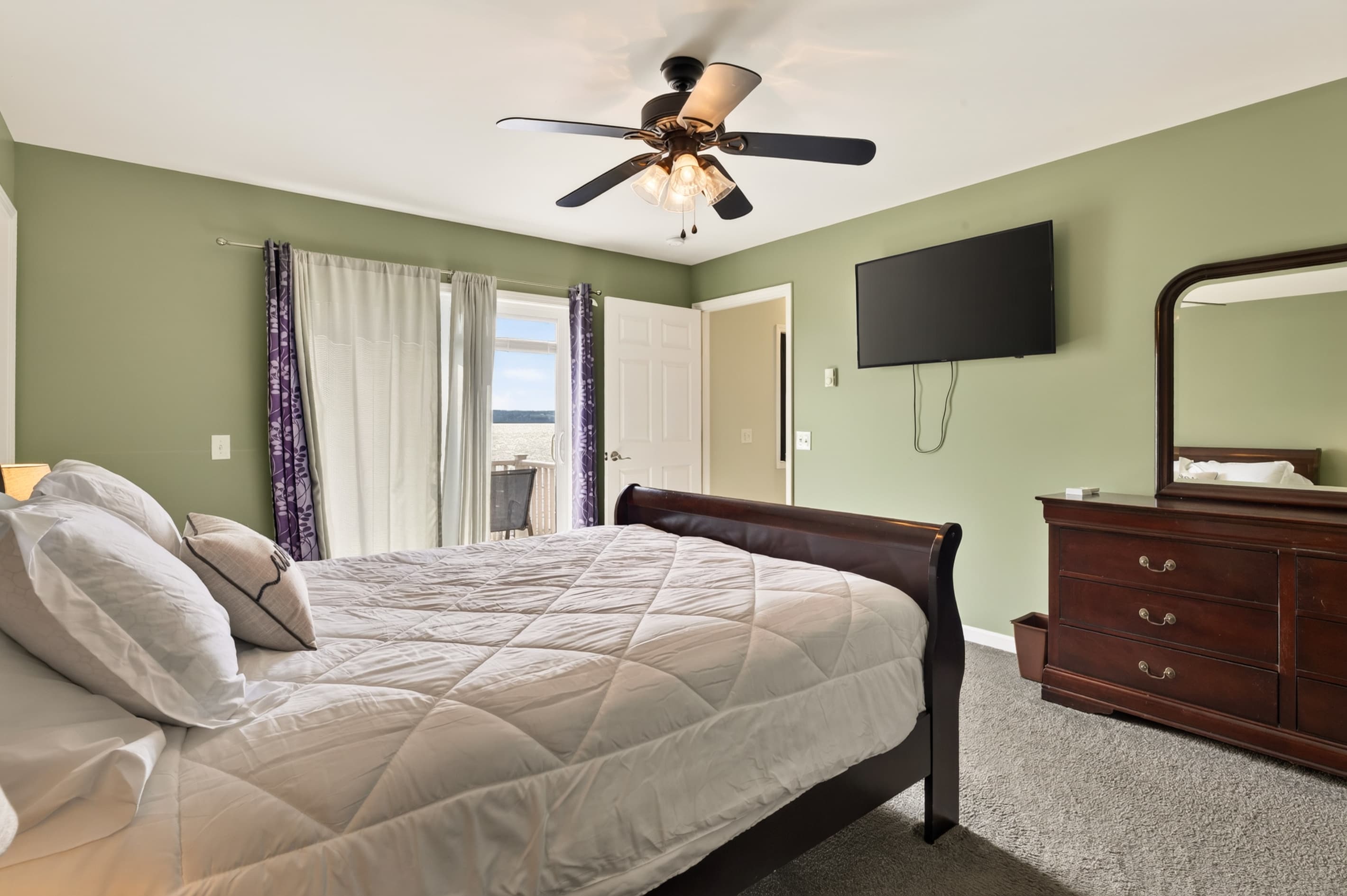 Bedroom with dresser and wall-mounted television