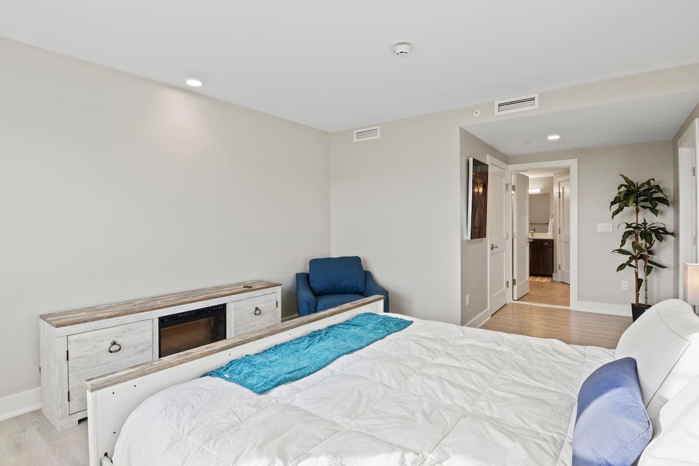 Bed facing the adjoining bathroom
