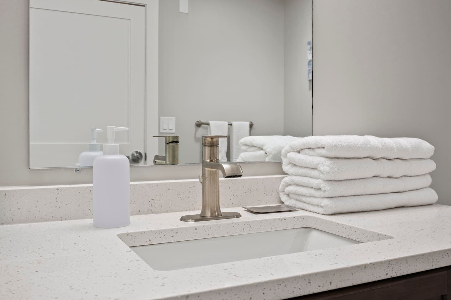 Fresh towels arranged beside the sink