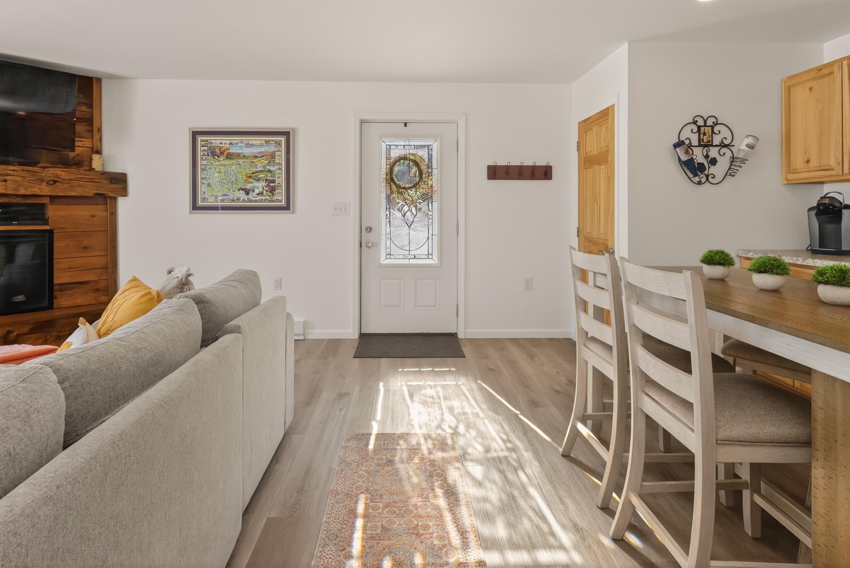 Main entry door with living area opposite the kitchen island seats