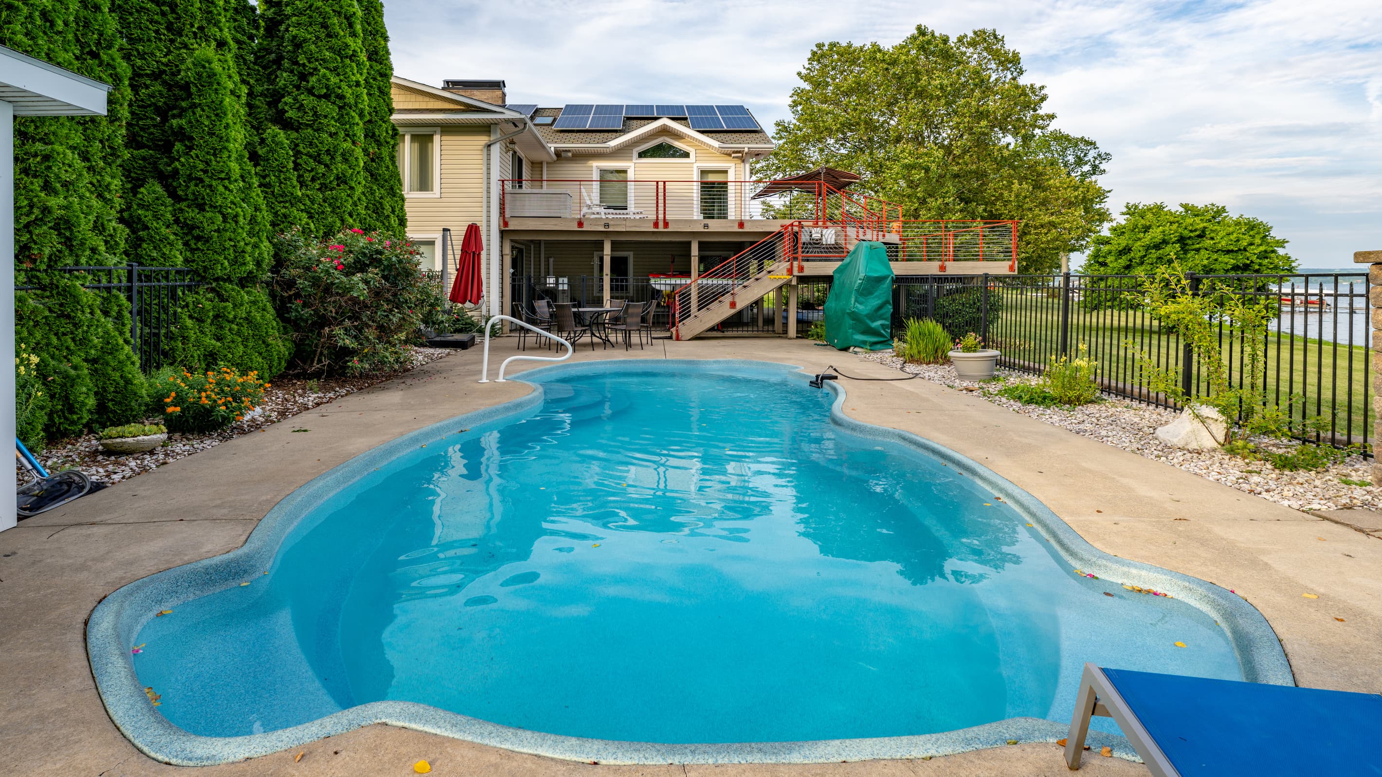 Fenced pool with lake view