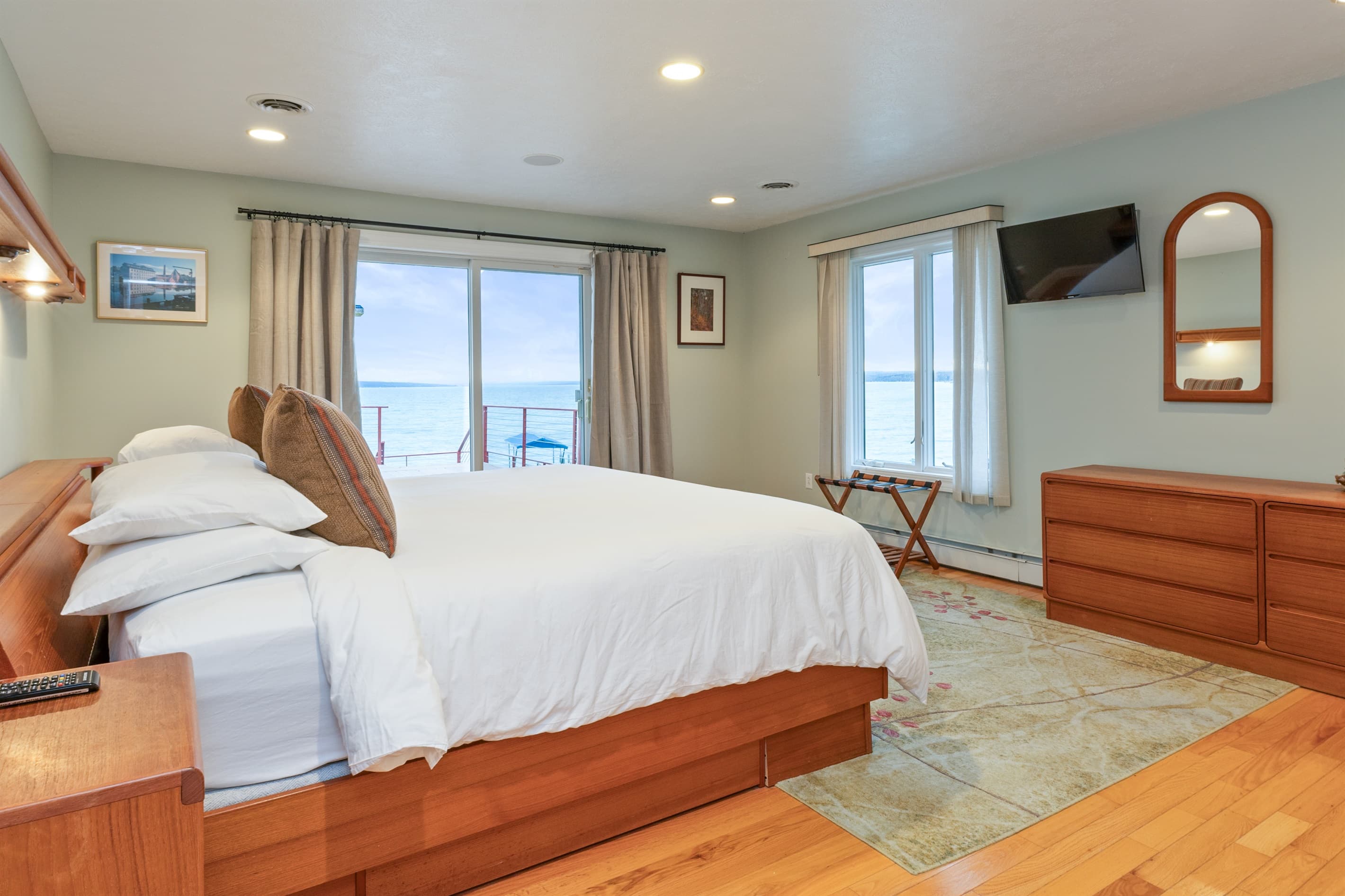 Bedroom with television and wooden dresser 