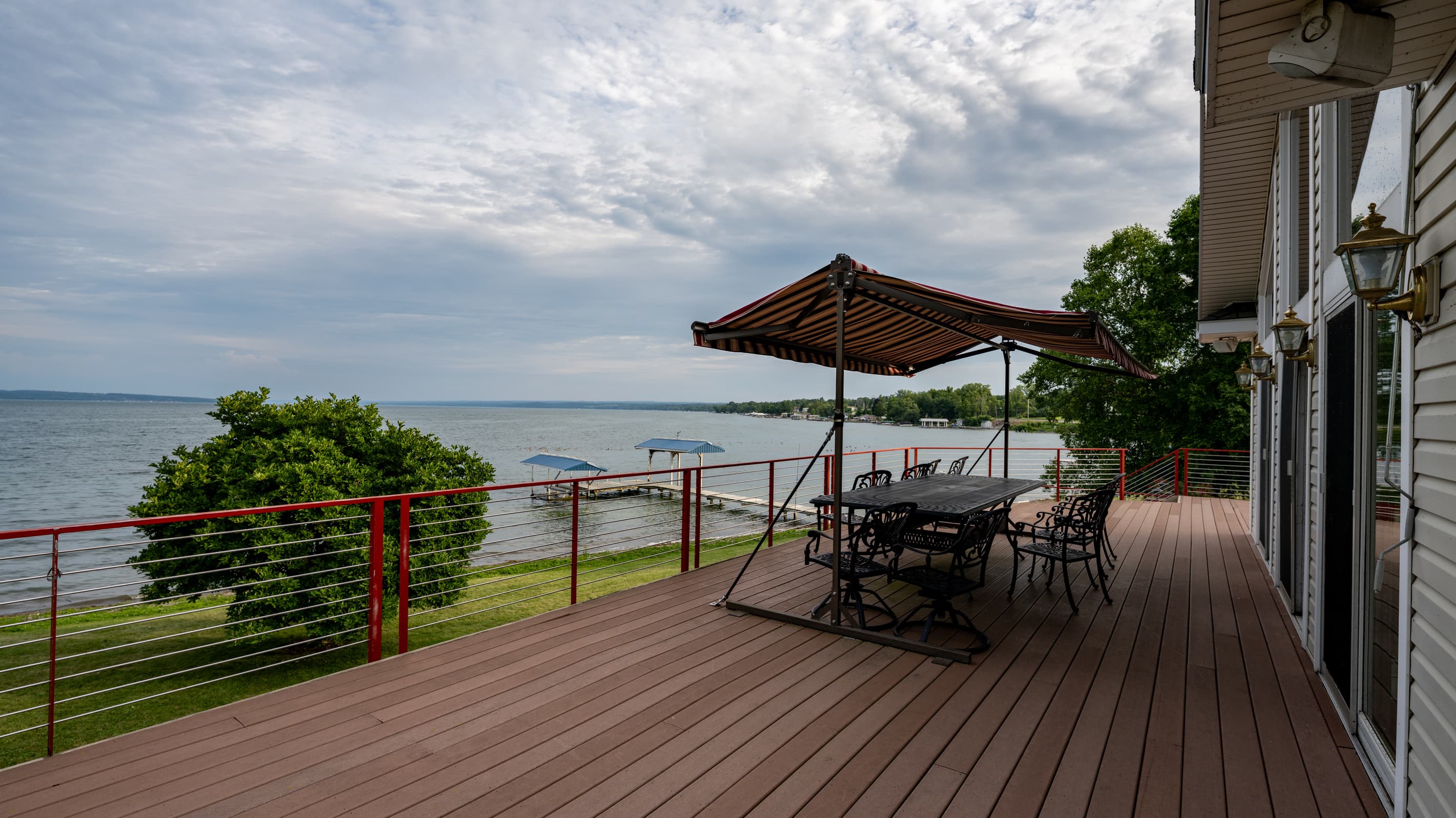 Umbrella-covered dining set on the wooden deck