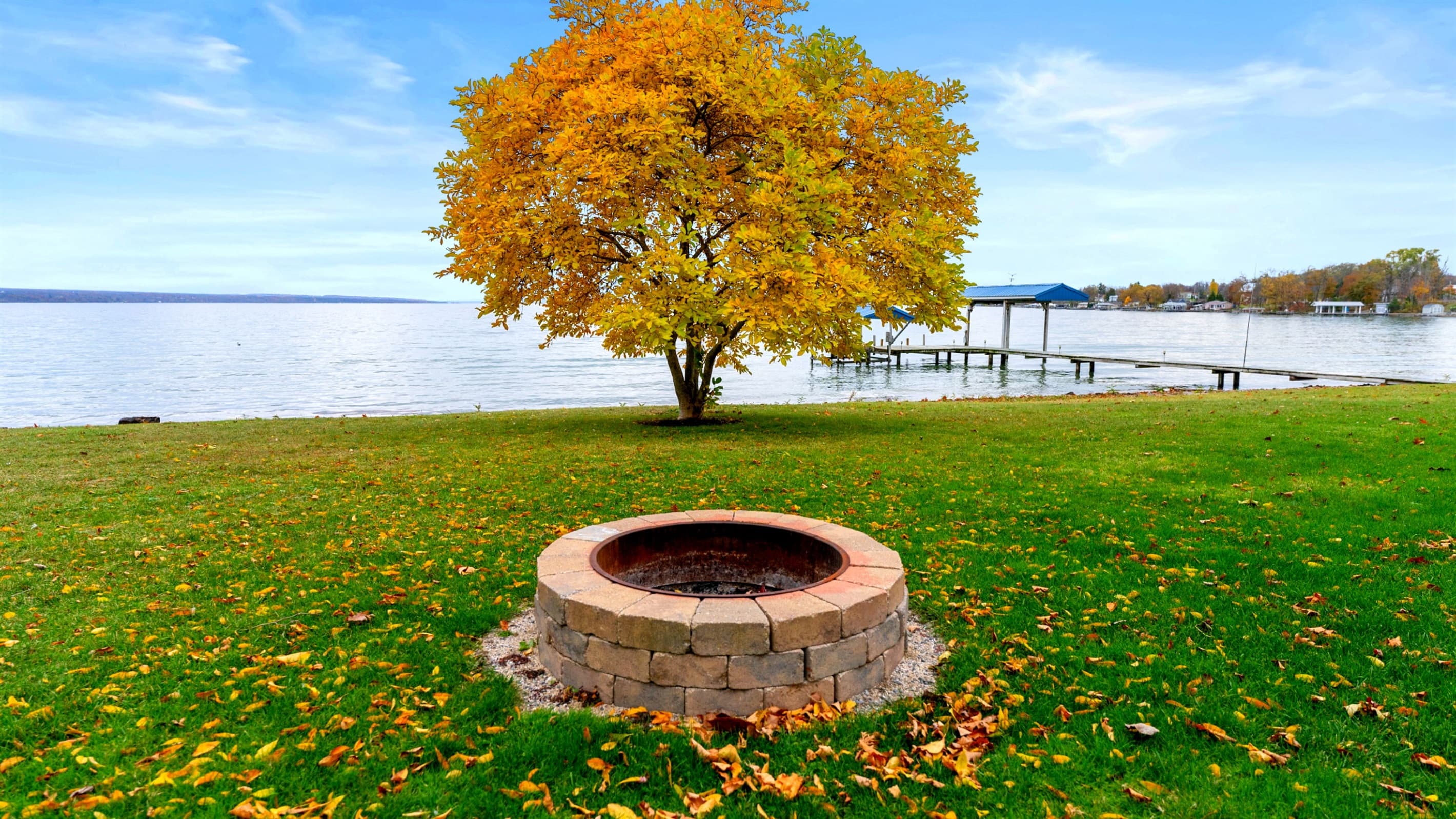 Lakeside fire pit with surrounding lawn