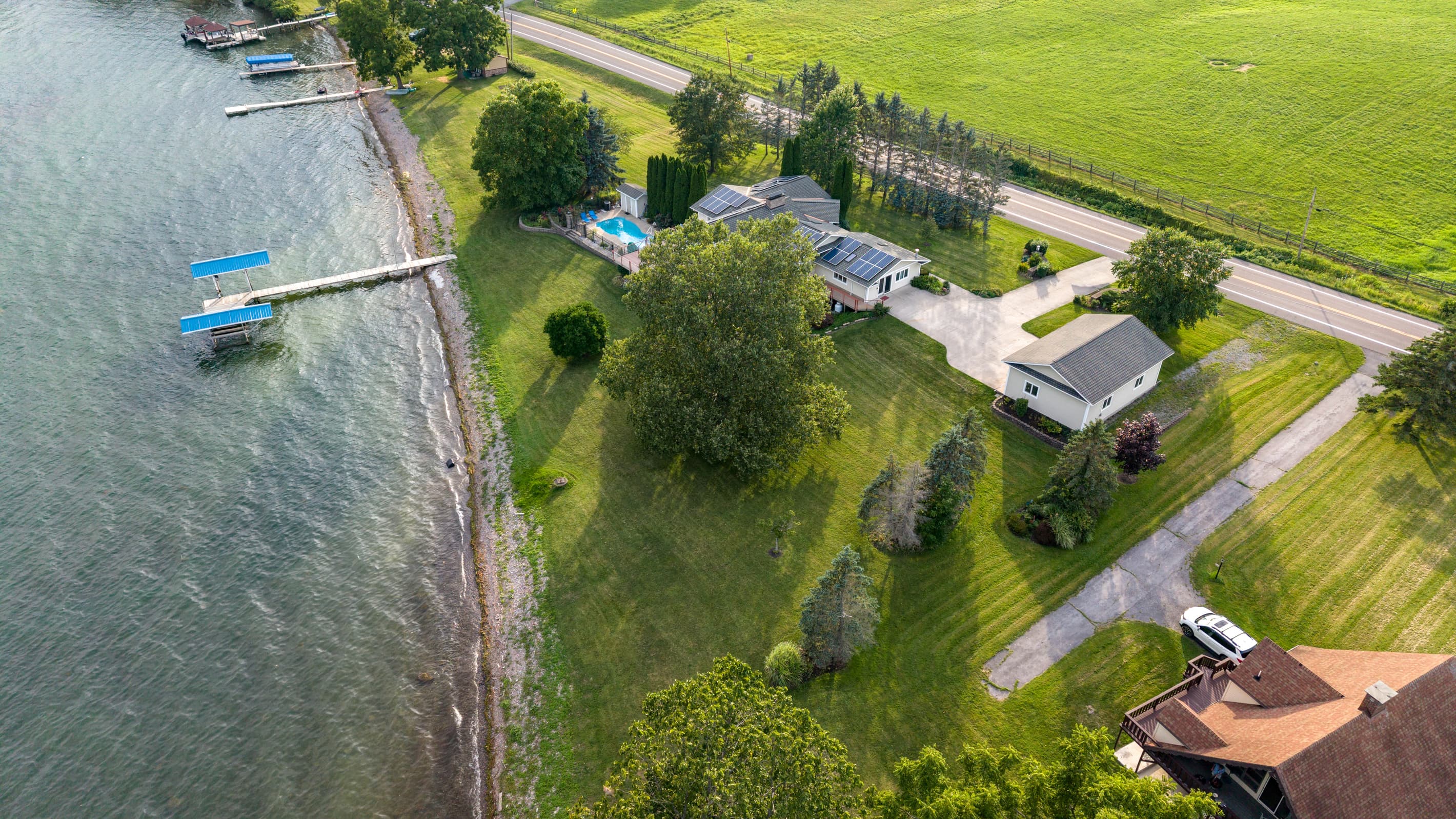 Long driveway extending from road to shoreline