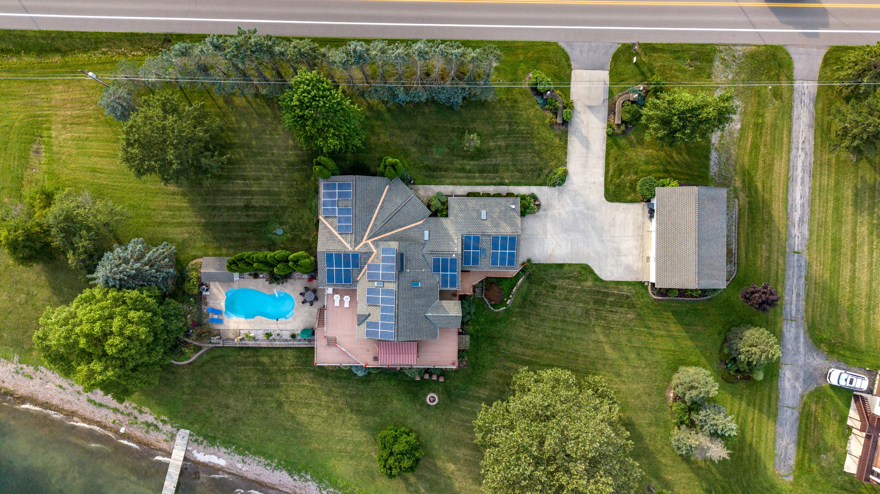 Top-down view of pool, house, and outbuilding