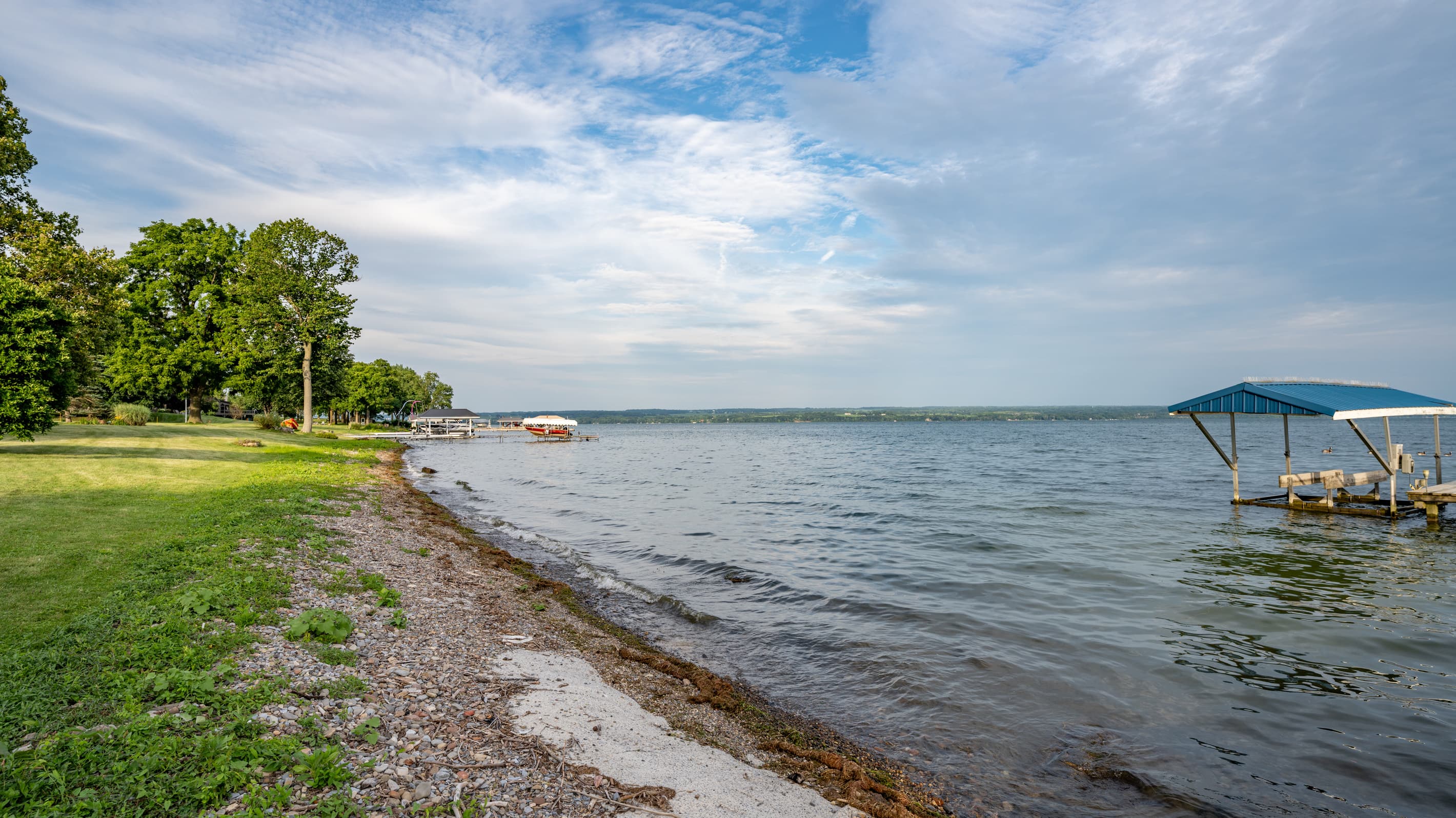 Tree-lined shore curving beside open water