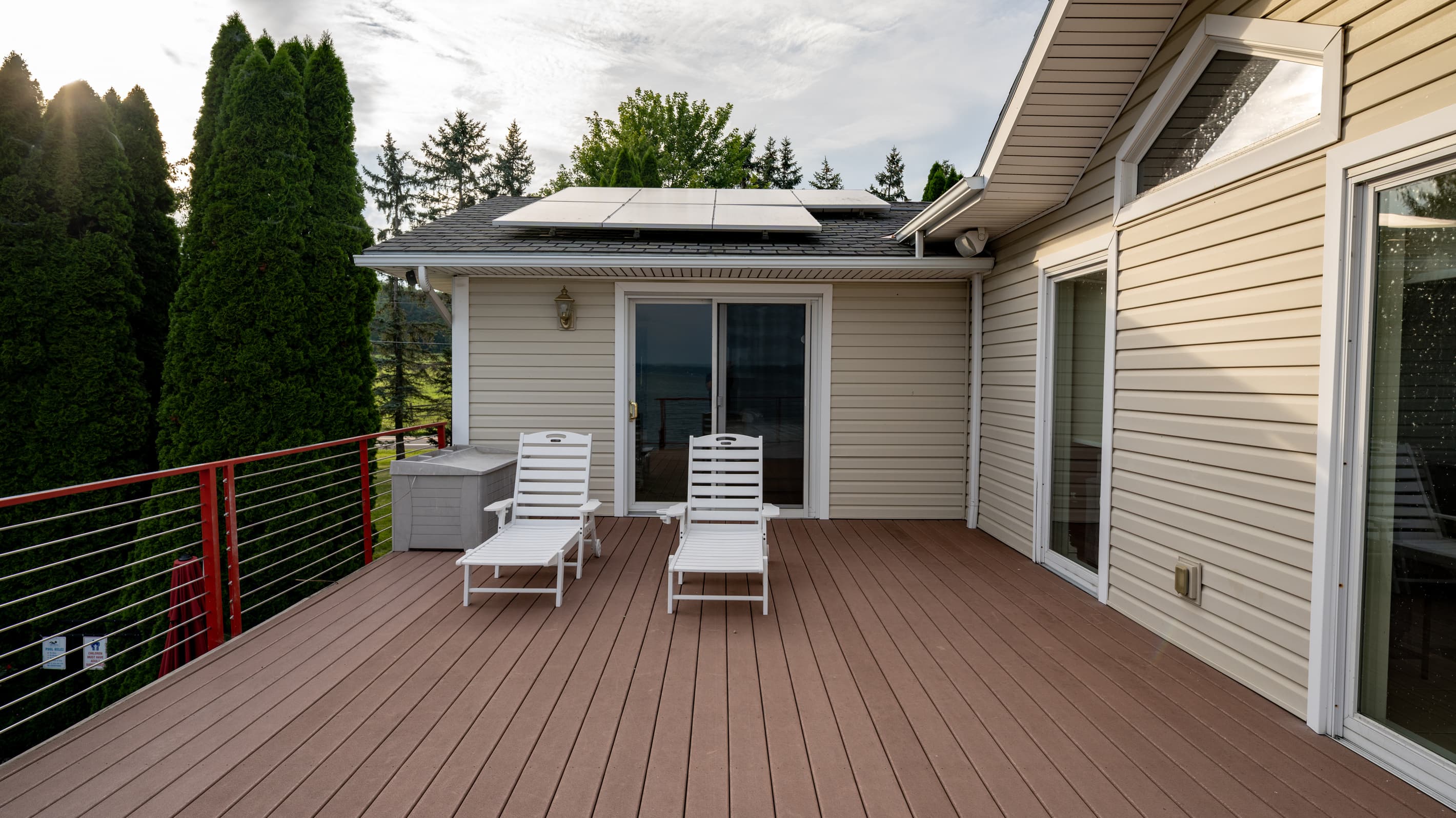 Two lounge chairs on the wide wooden deck