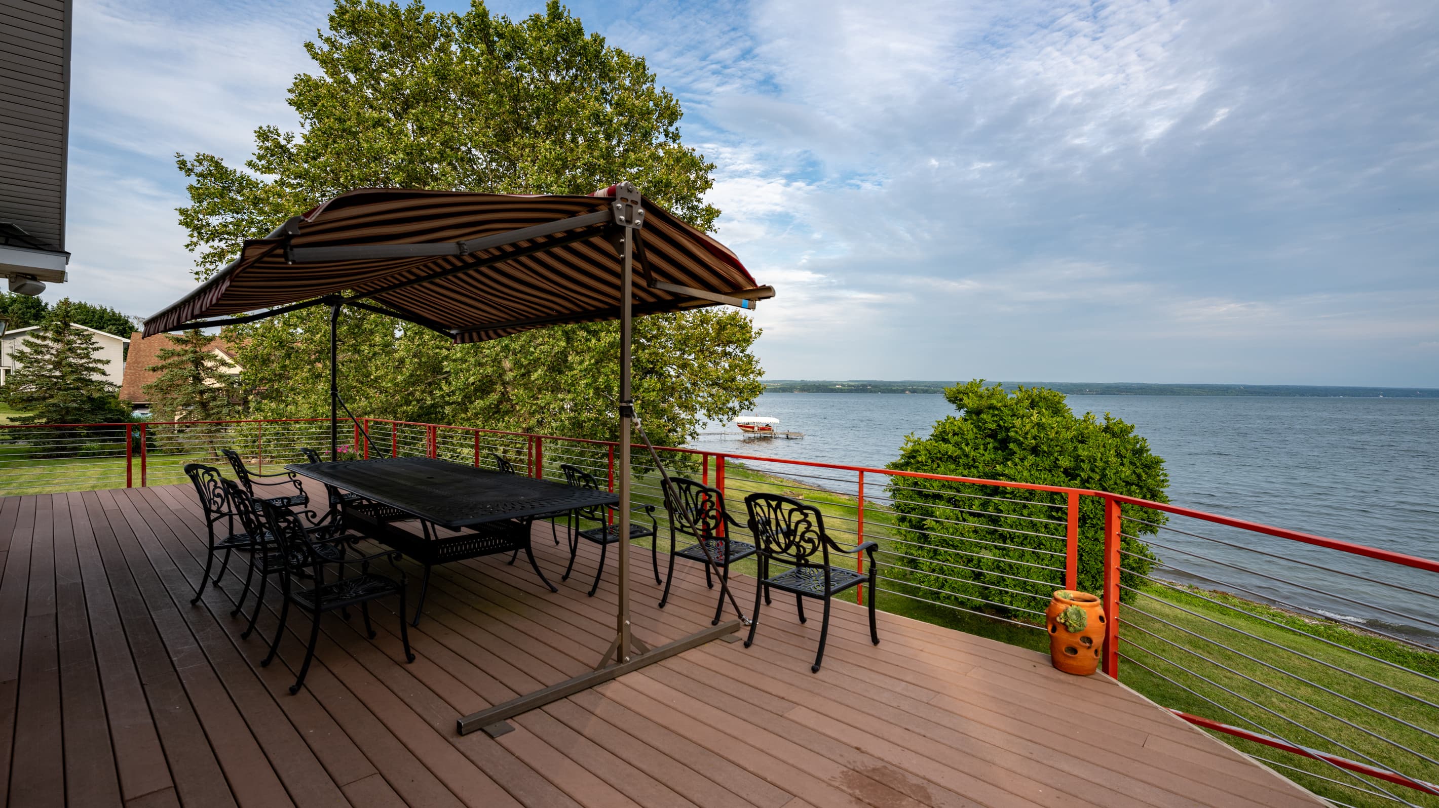 Pergola-covered dining table overlooking the water