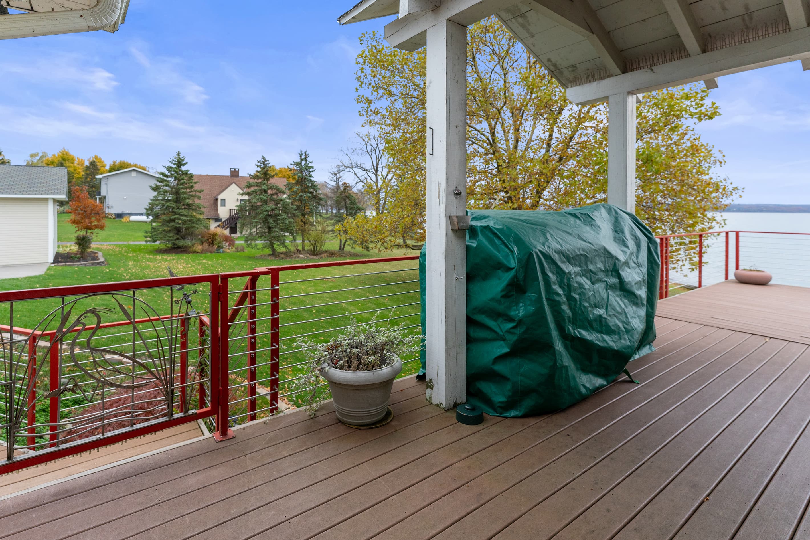 Covered outdoor grill on wooden deck 