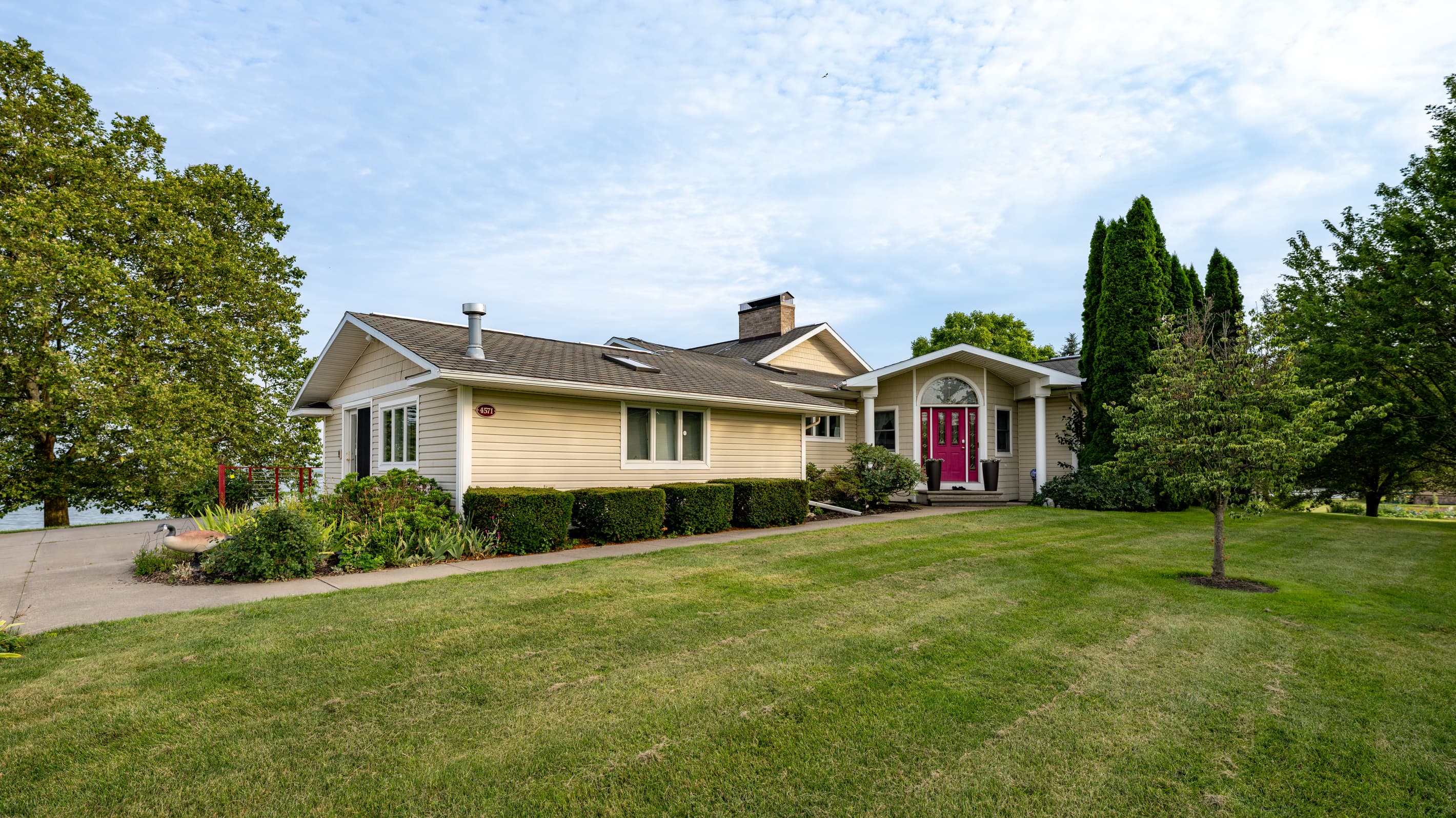 Front exterior with walkway and red entry door
