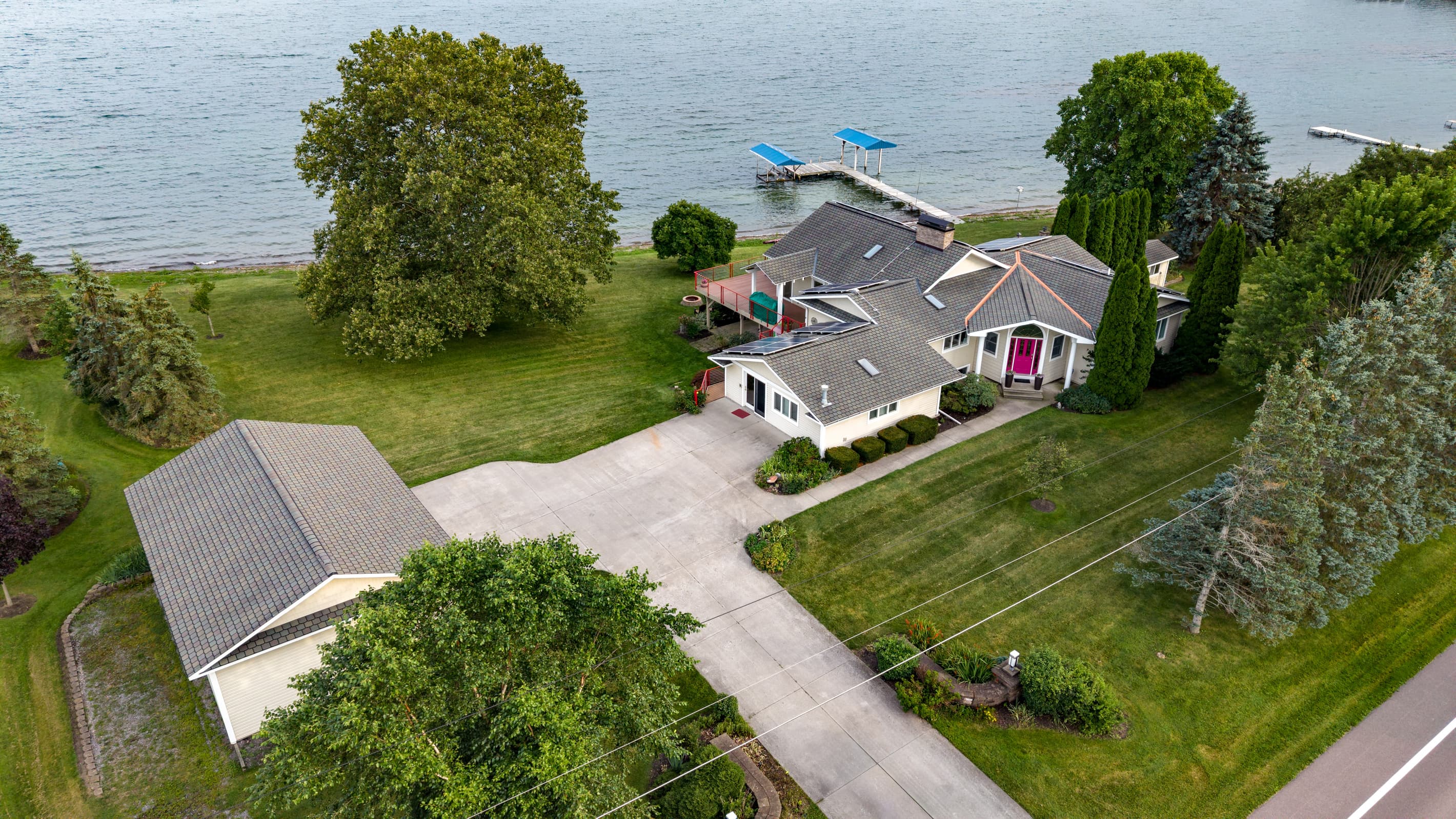 Overhead view of driveway, garage, and residence