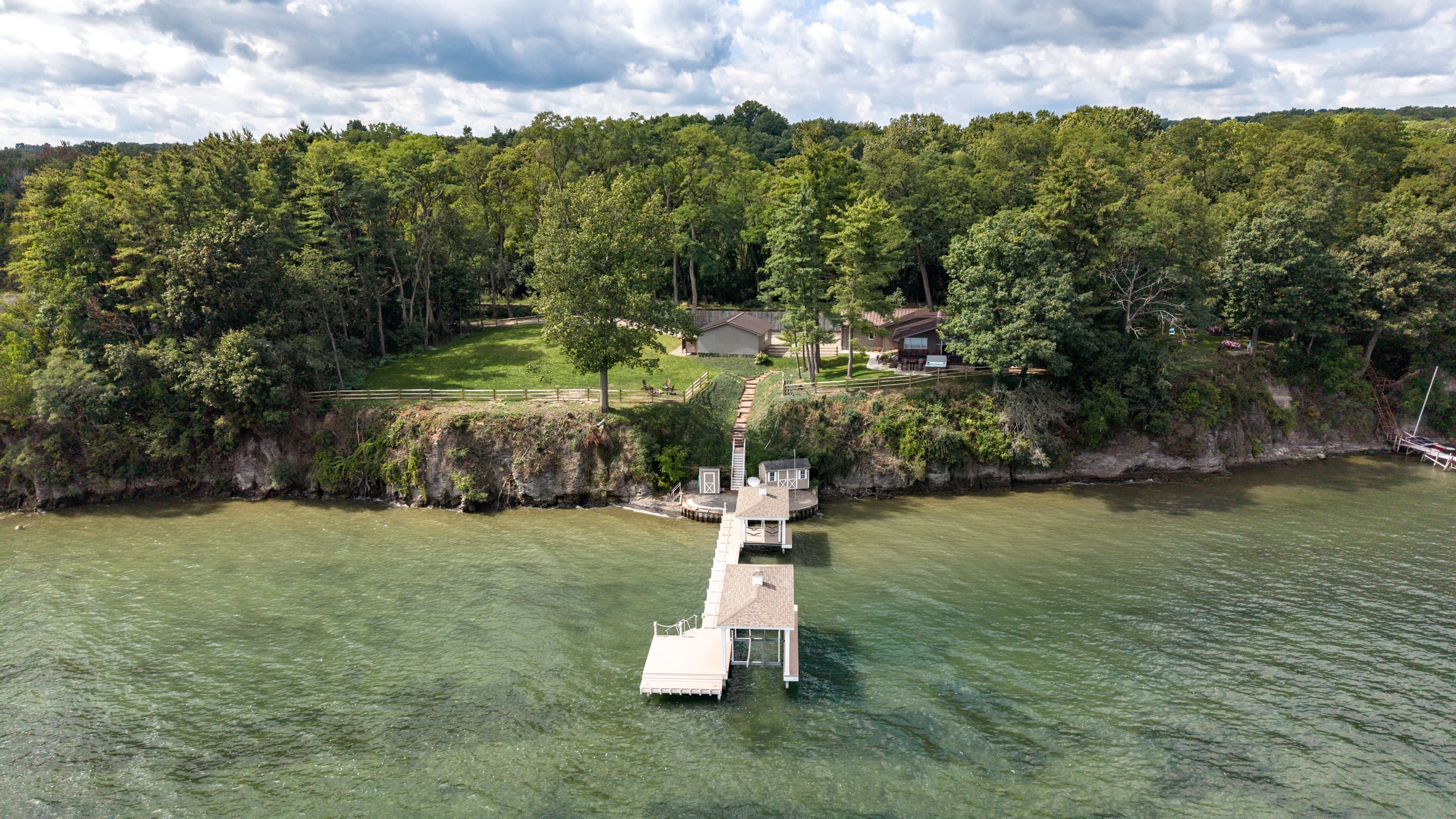 Lakefront property with lawn and dock