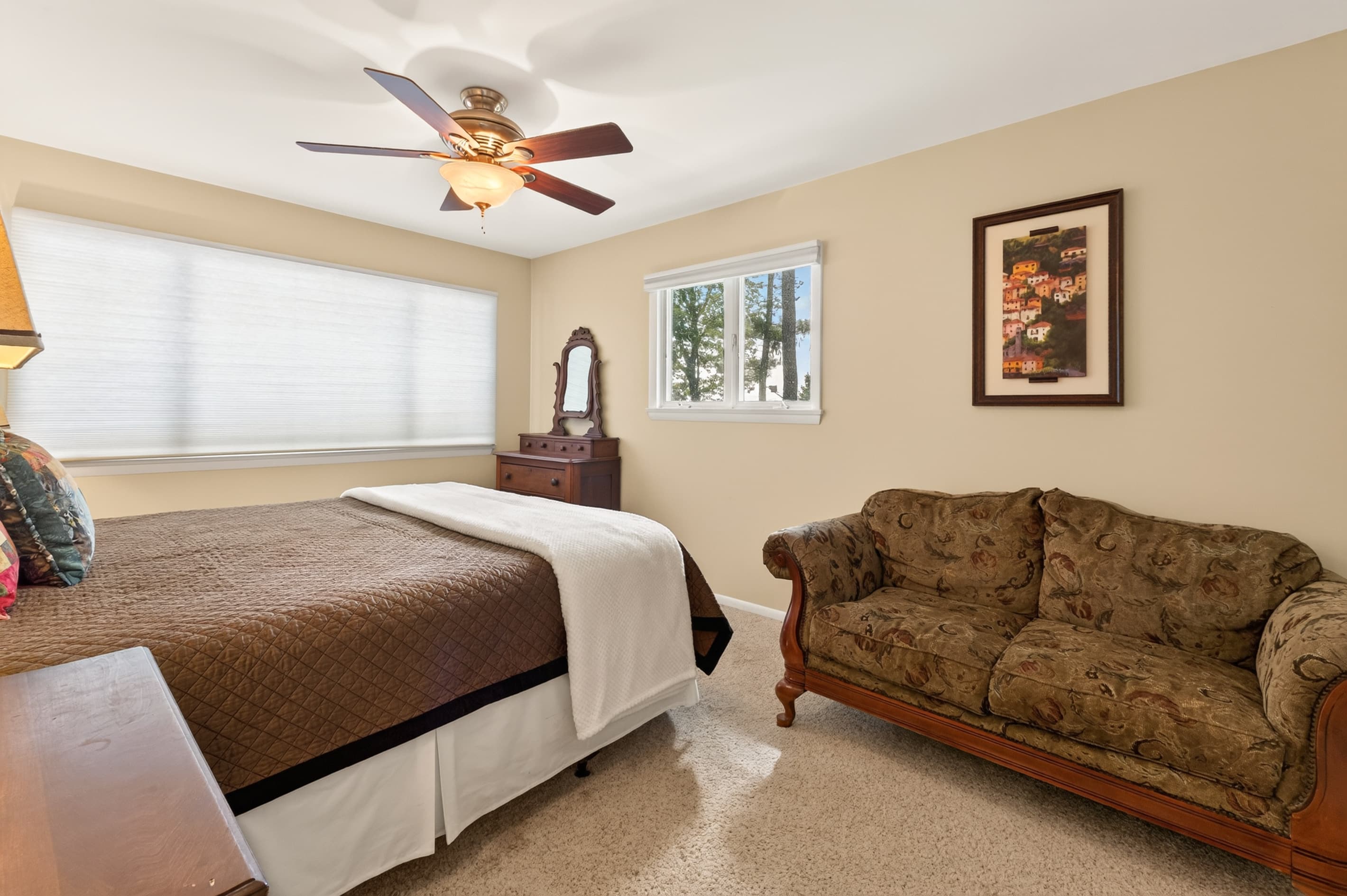 Bedroom with queen bed and sofa