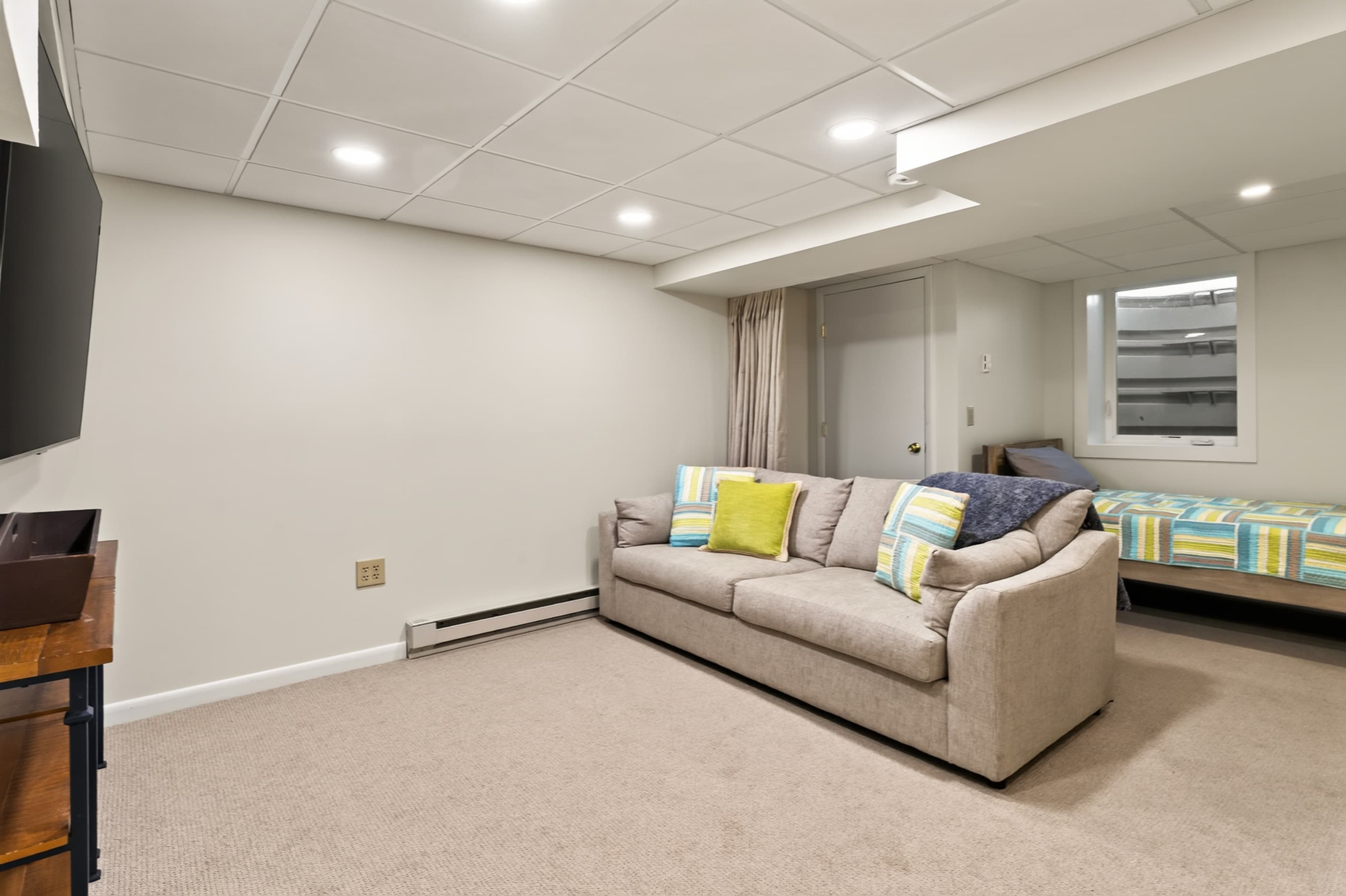 Lower-level sitting room with sofa