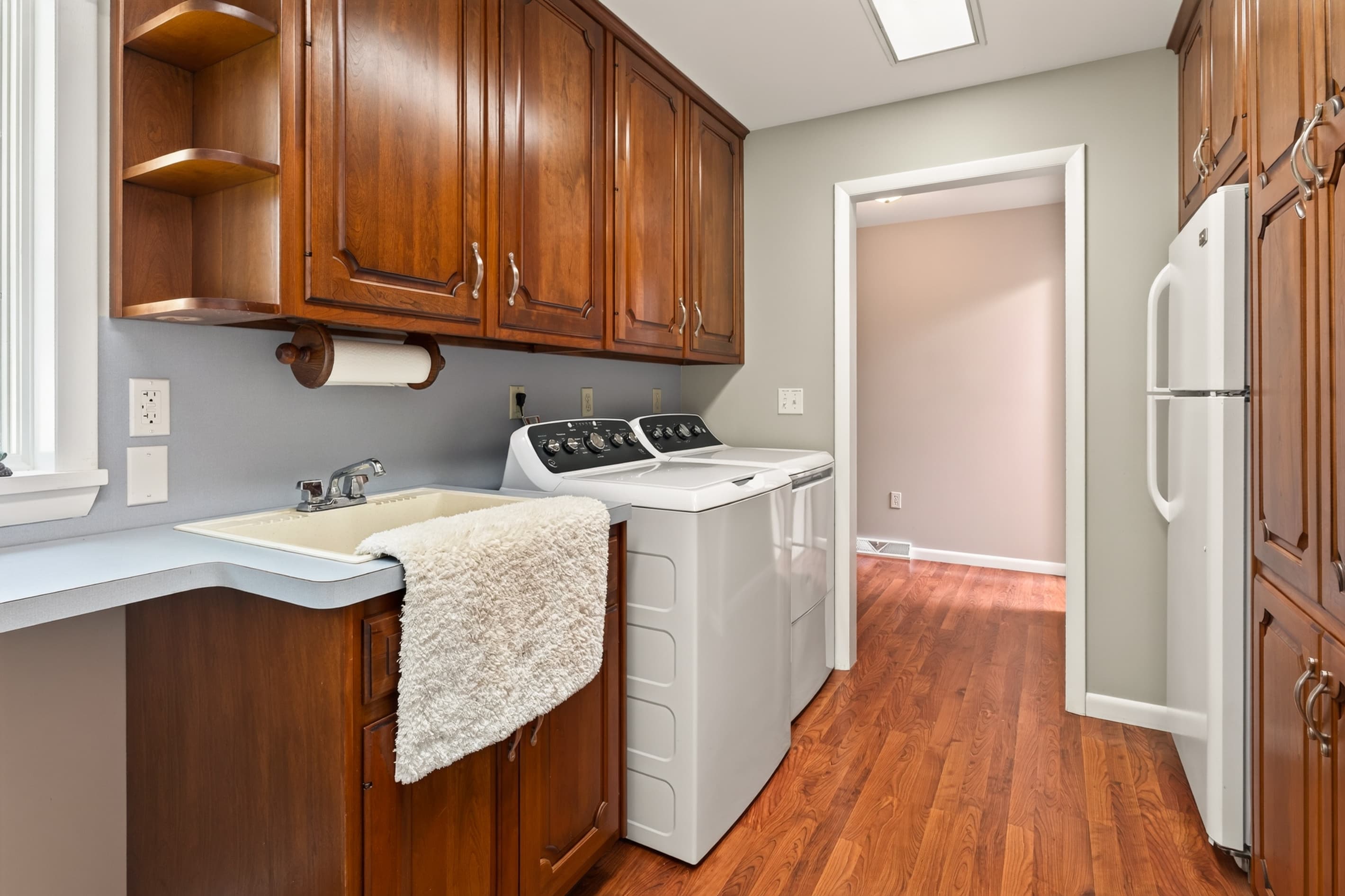 Utility room with sink and cabinetry