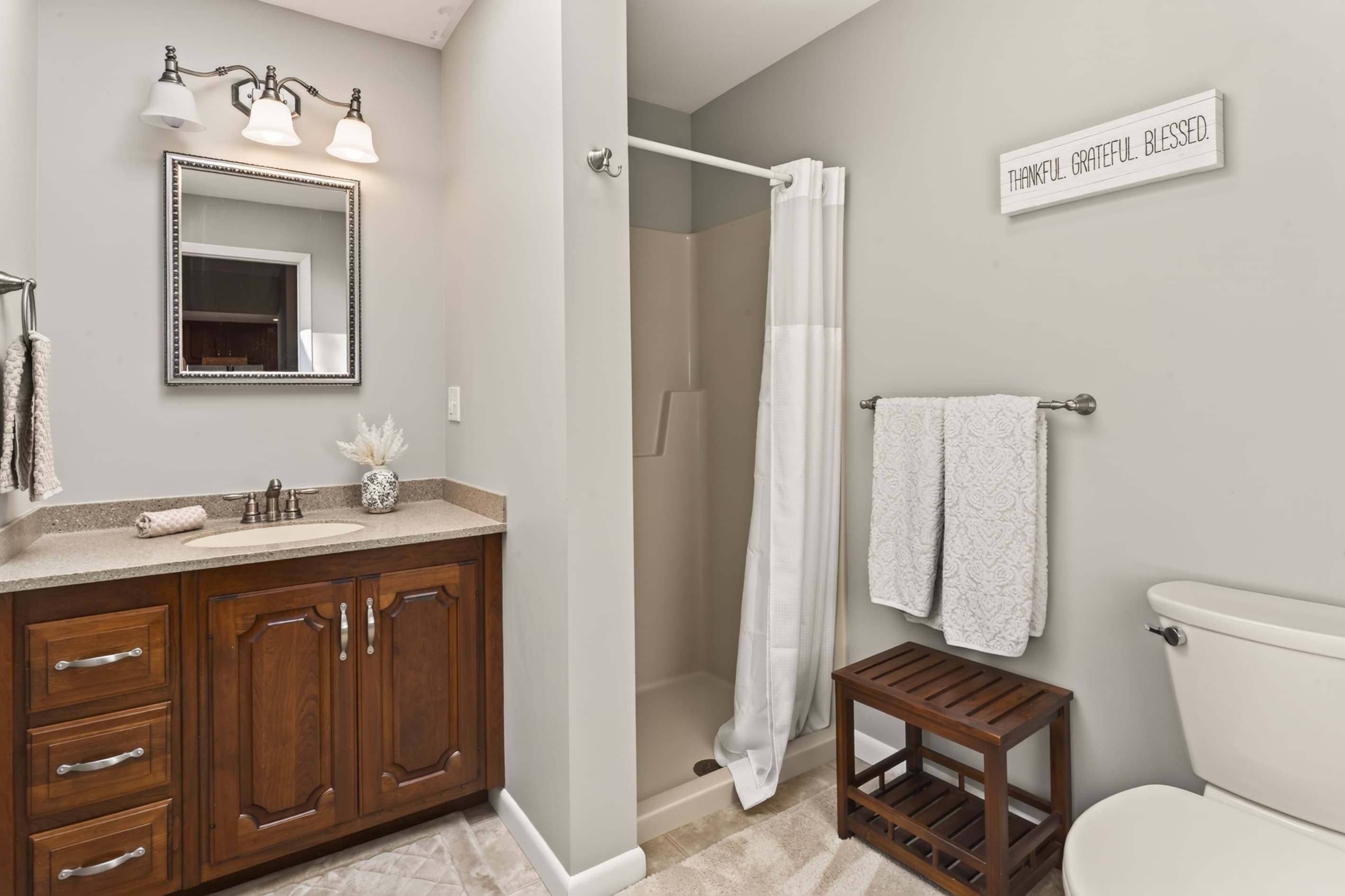 Wood vanity beside the tub shower