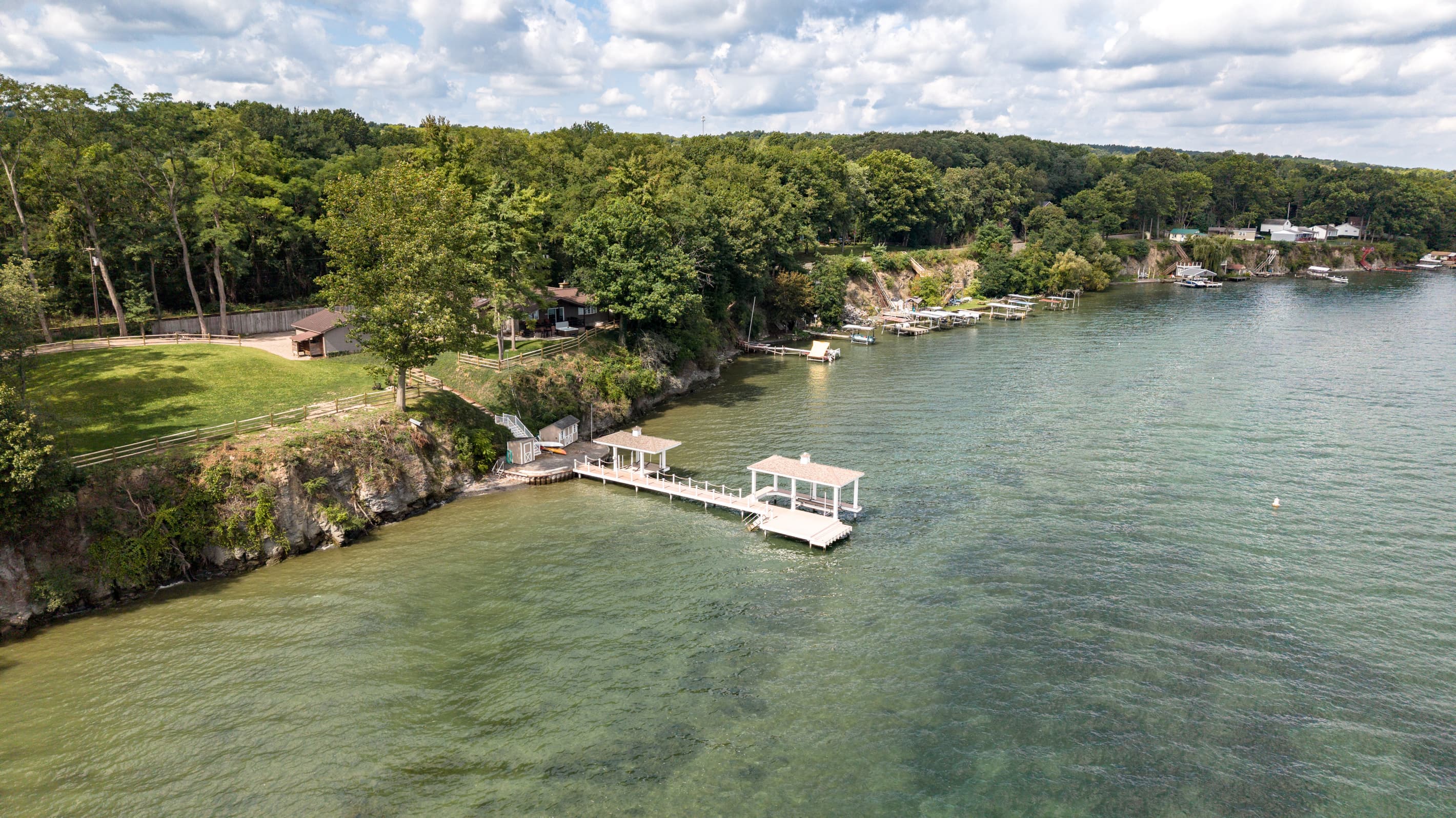 Private dock extending from wooded shore
