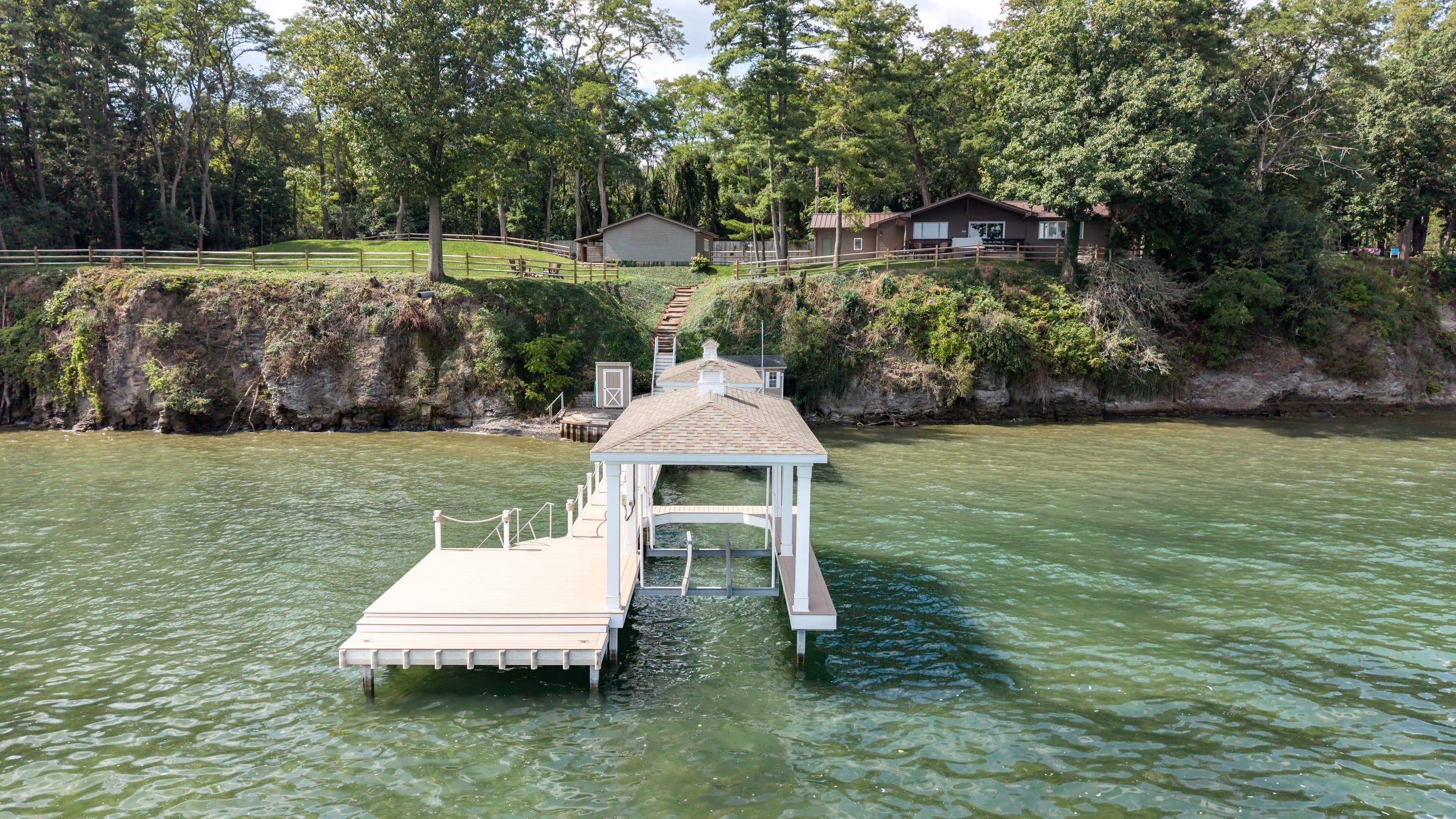 Covered boat lift and adjoining dock