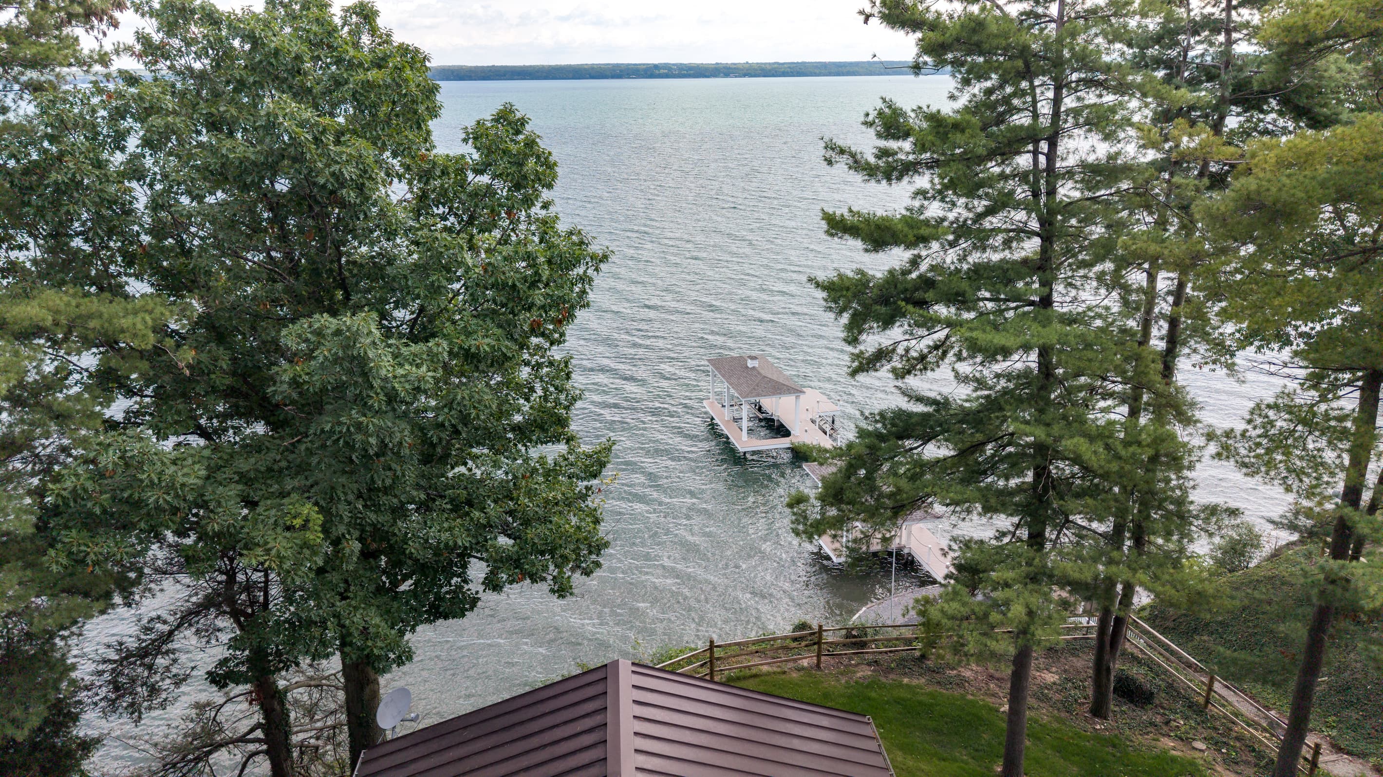 Dock visible through lakeside trees