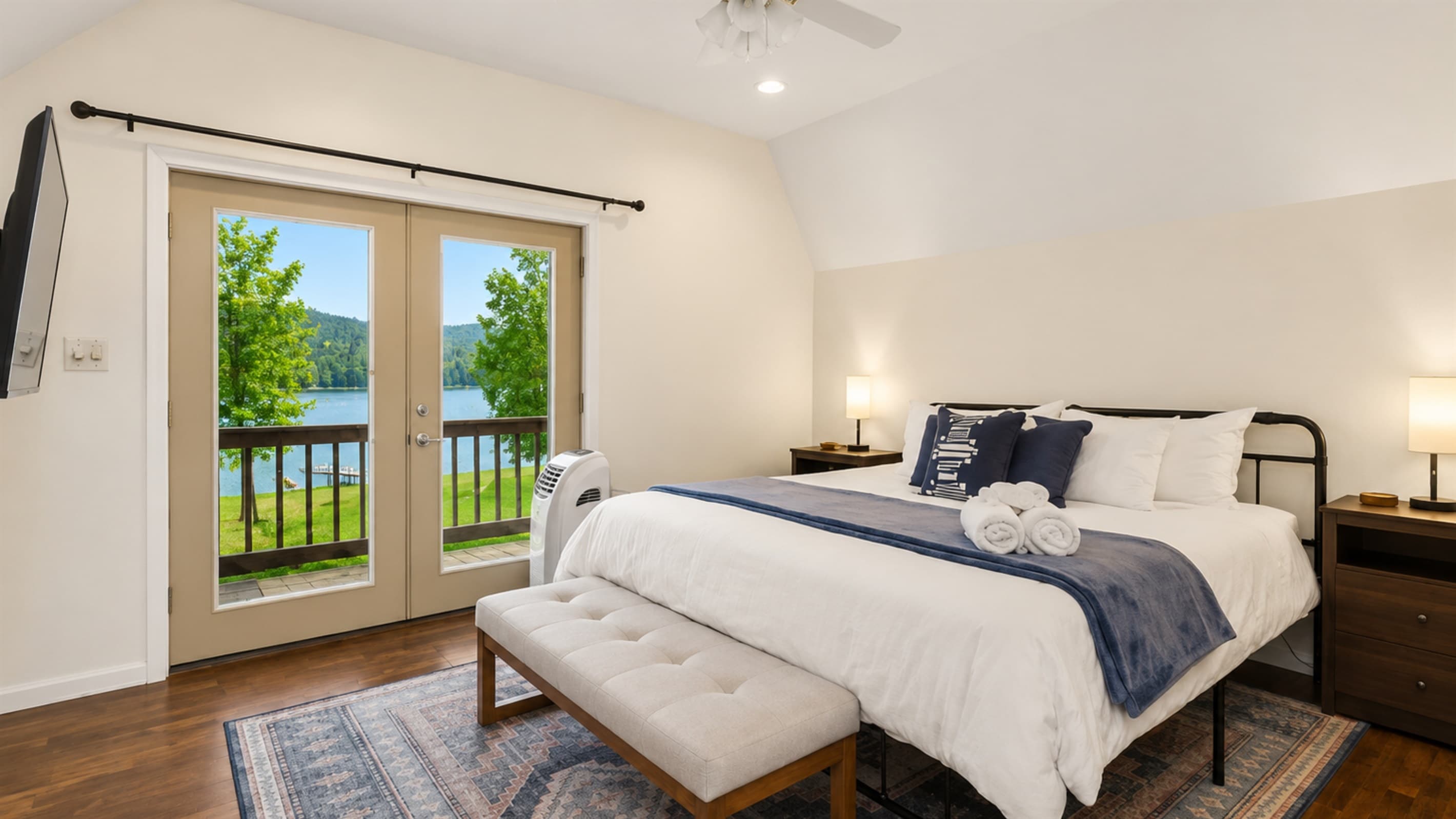 Bedroom with queen bed and corner windows
