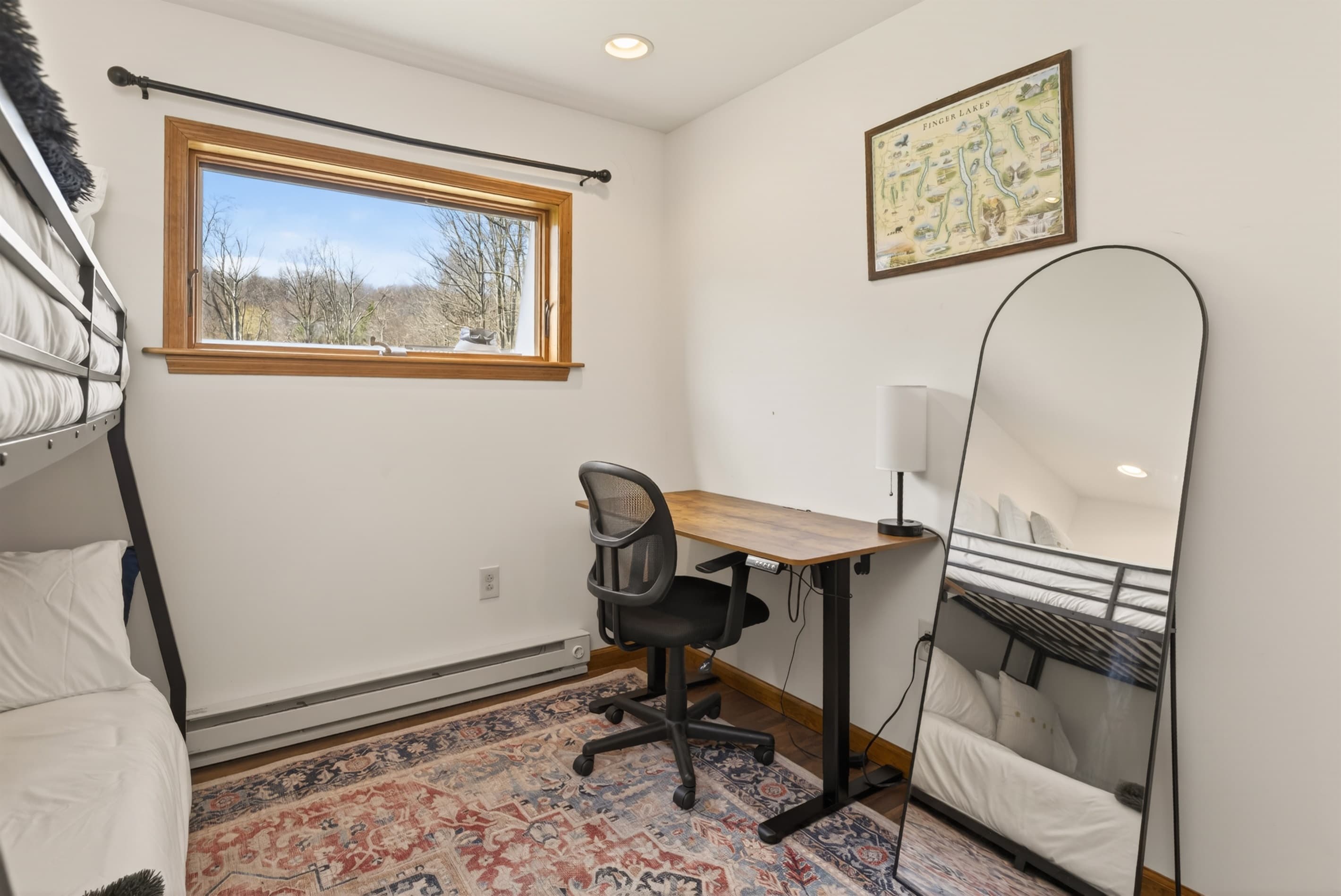 Guest bedroom with desk and additional sleeping space
