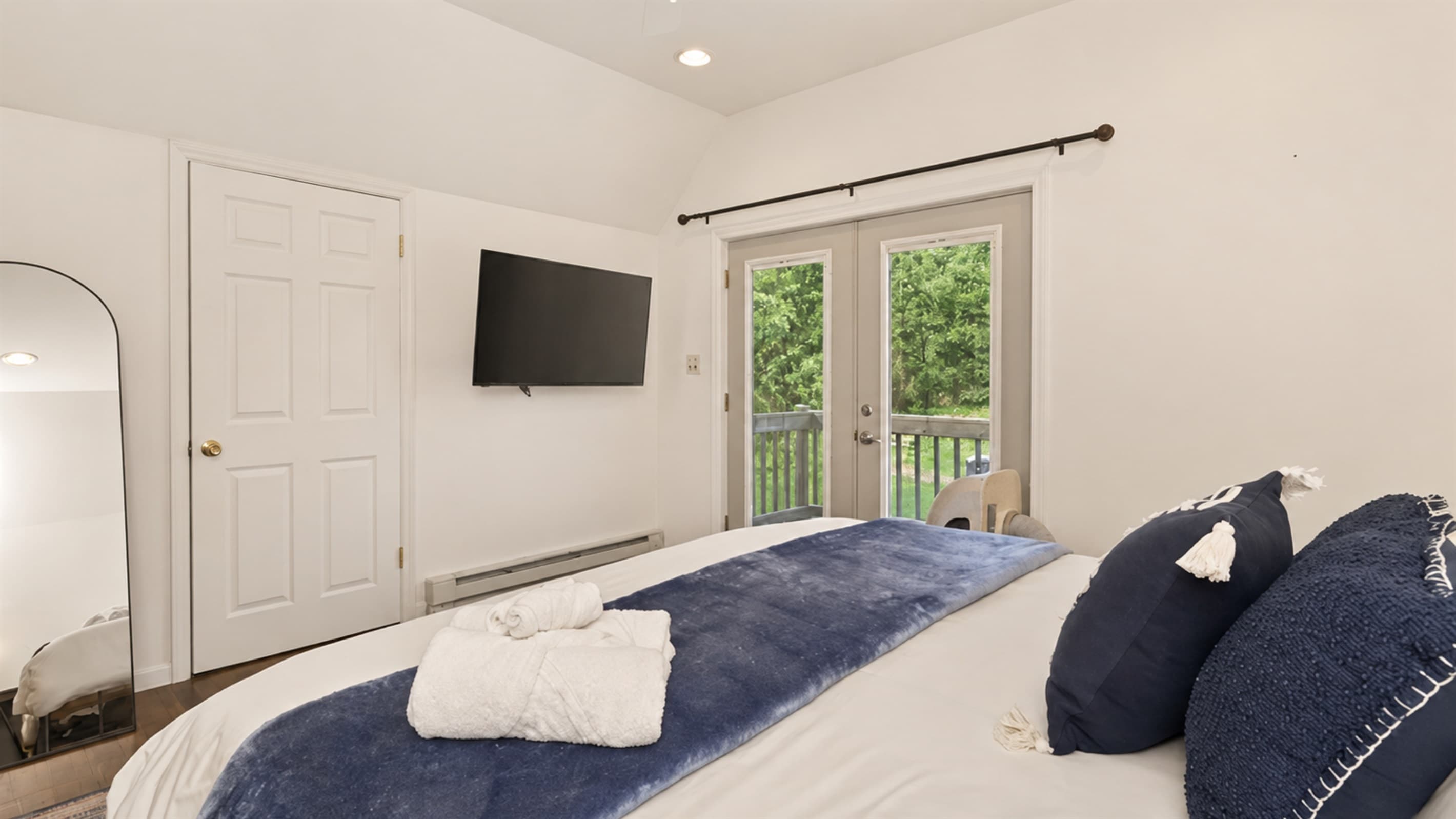 Wall-mounted television across from the bed