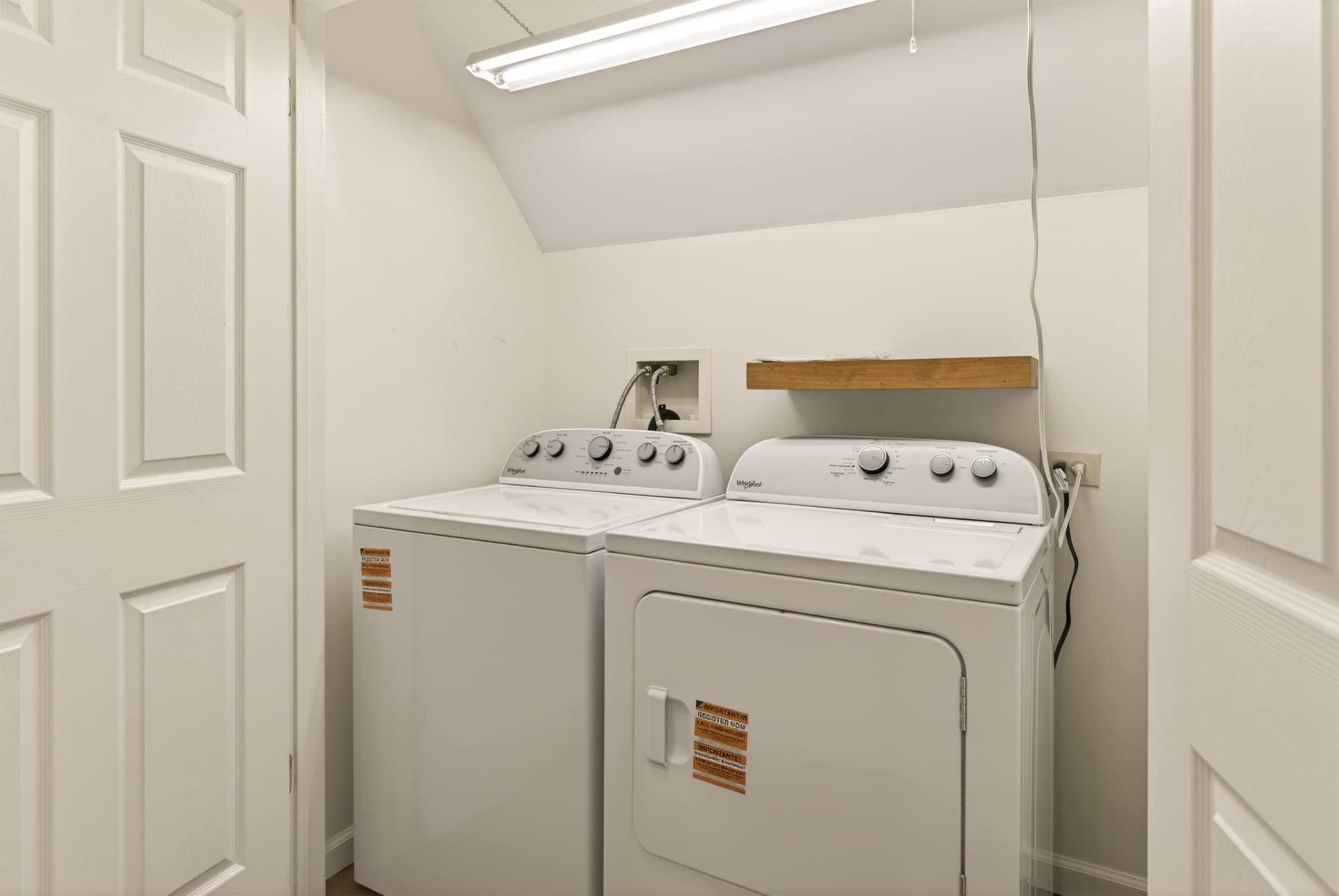 Laundry area with stacked washer and dryer