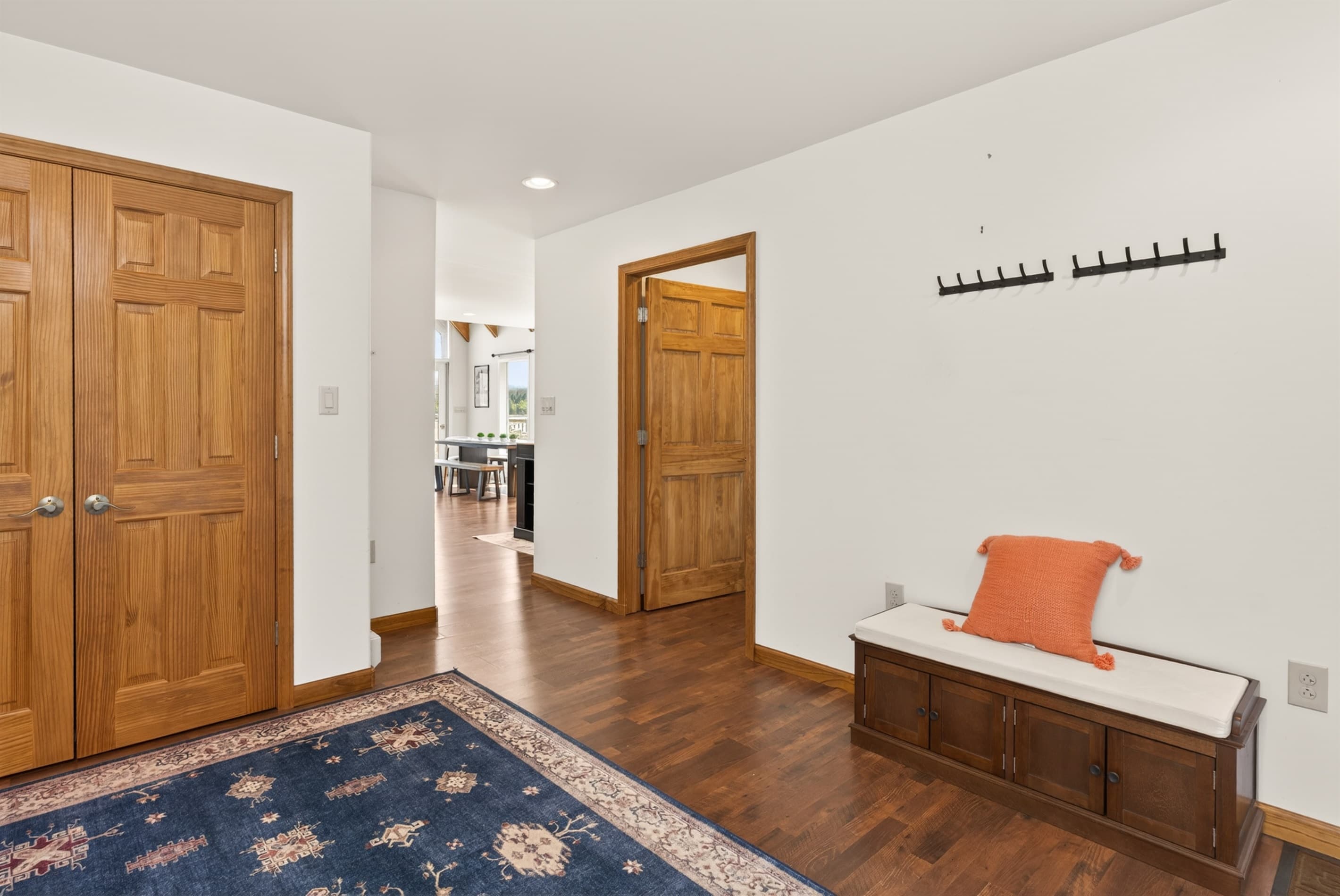 Bedroom dresser with wall-mounted coat hooks