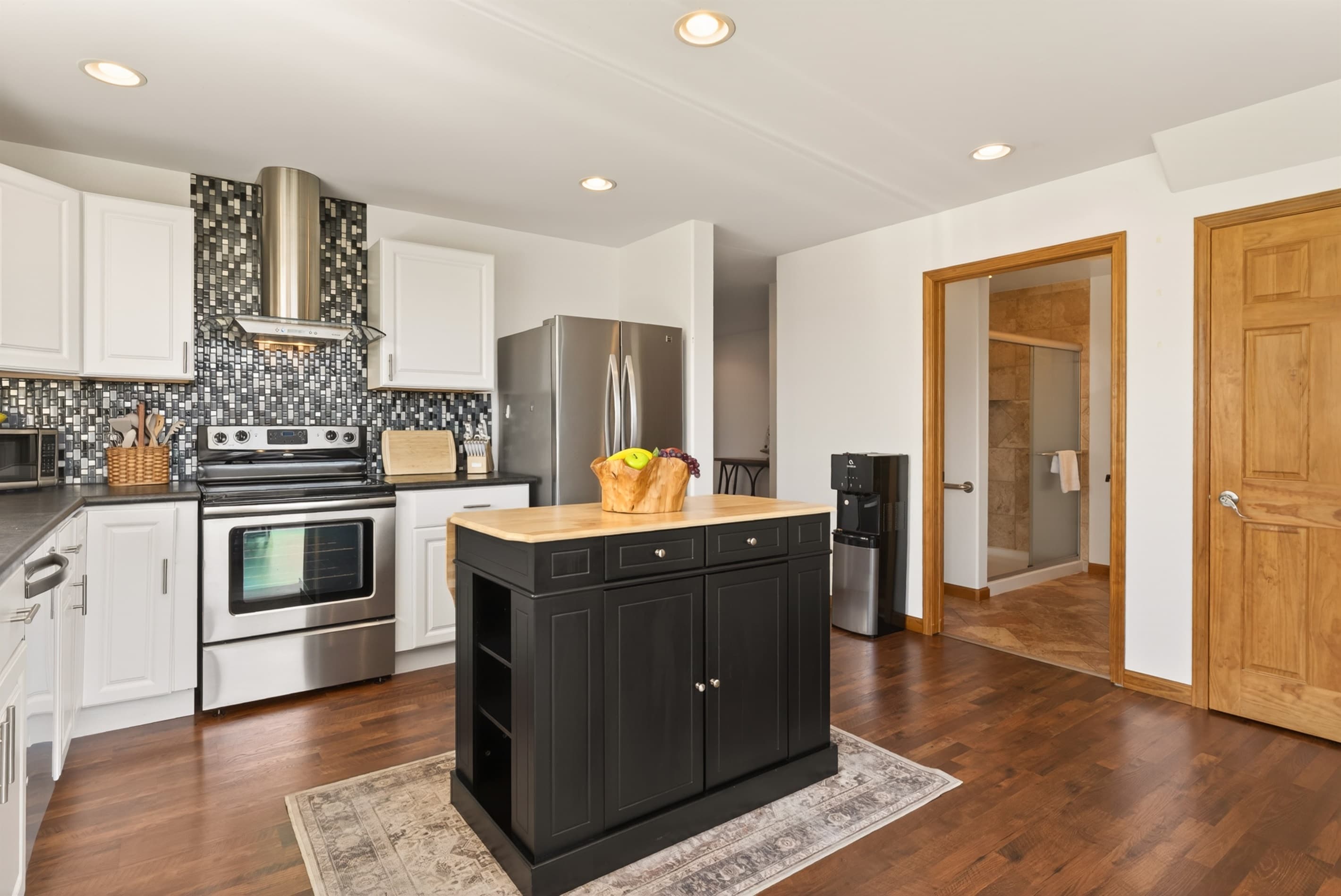 Open kitchen with island and stainless appliances