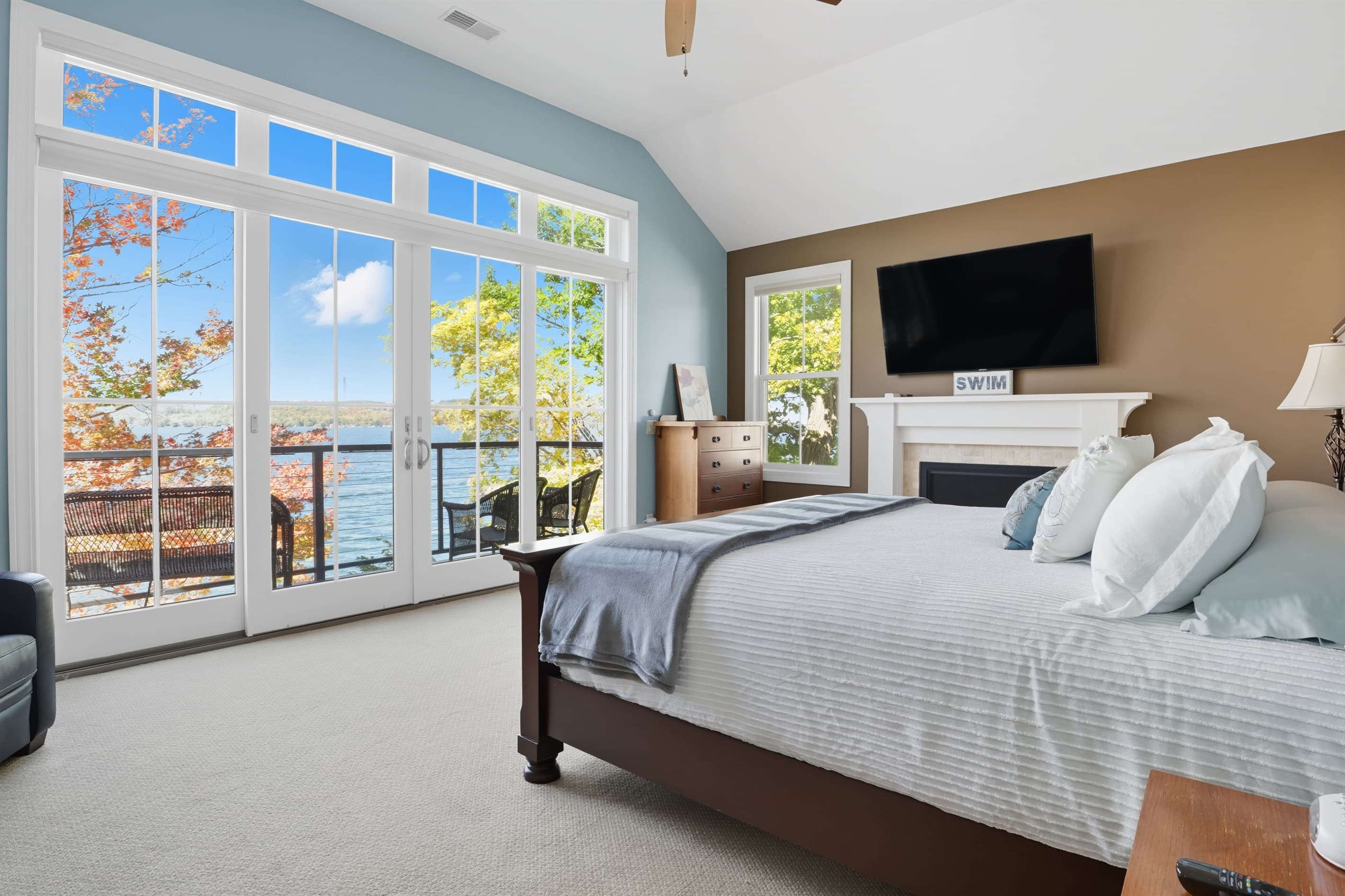 Bedroom with wall-mounted television and private balcony