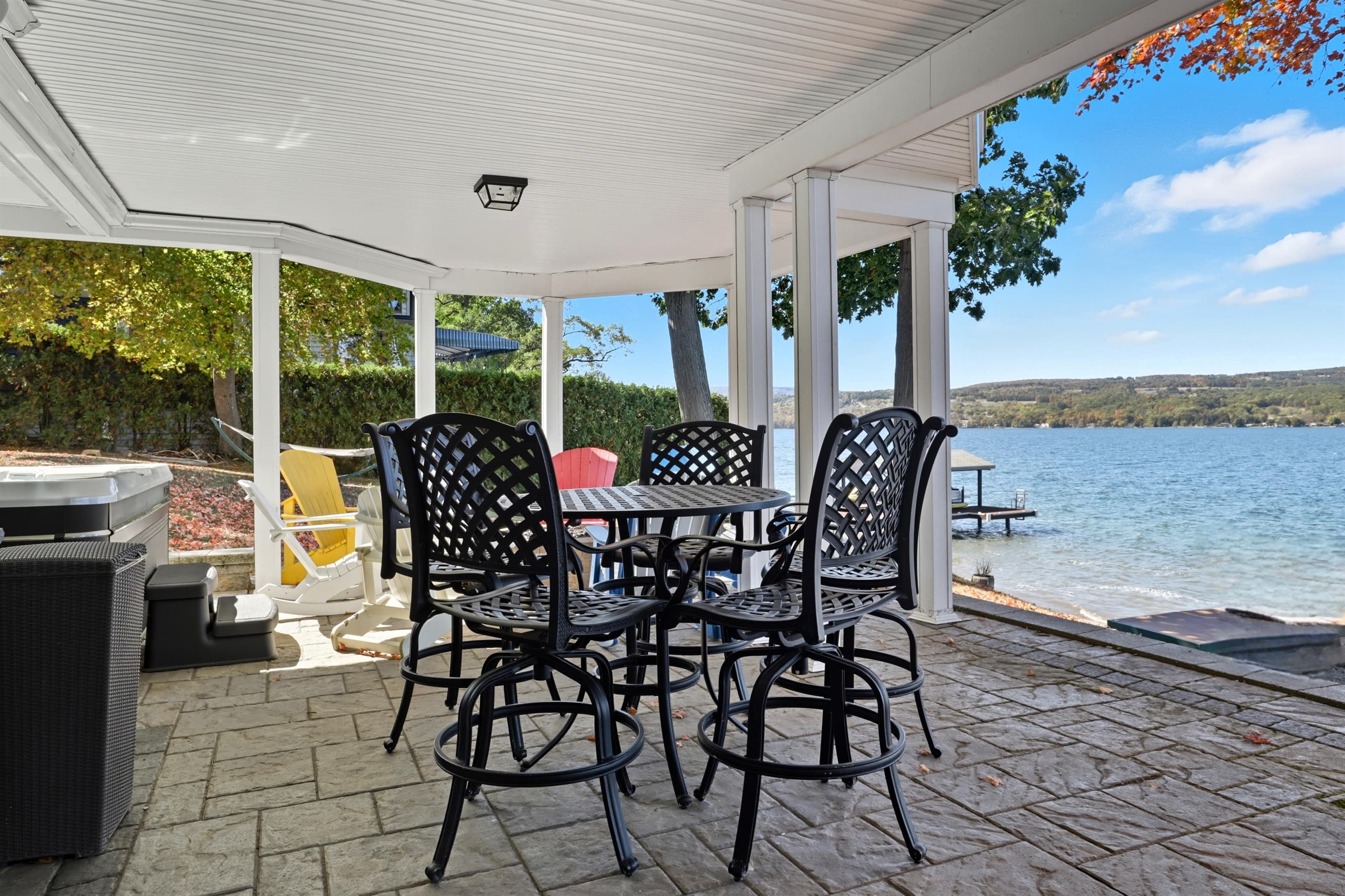 Covered patio dining area overlooking the water
